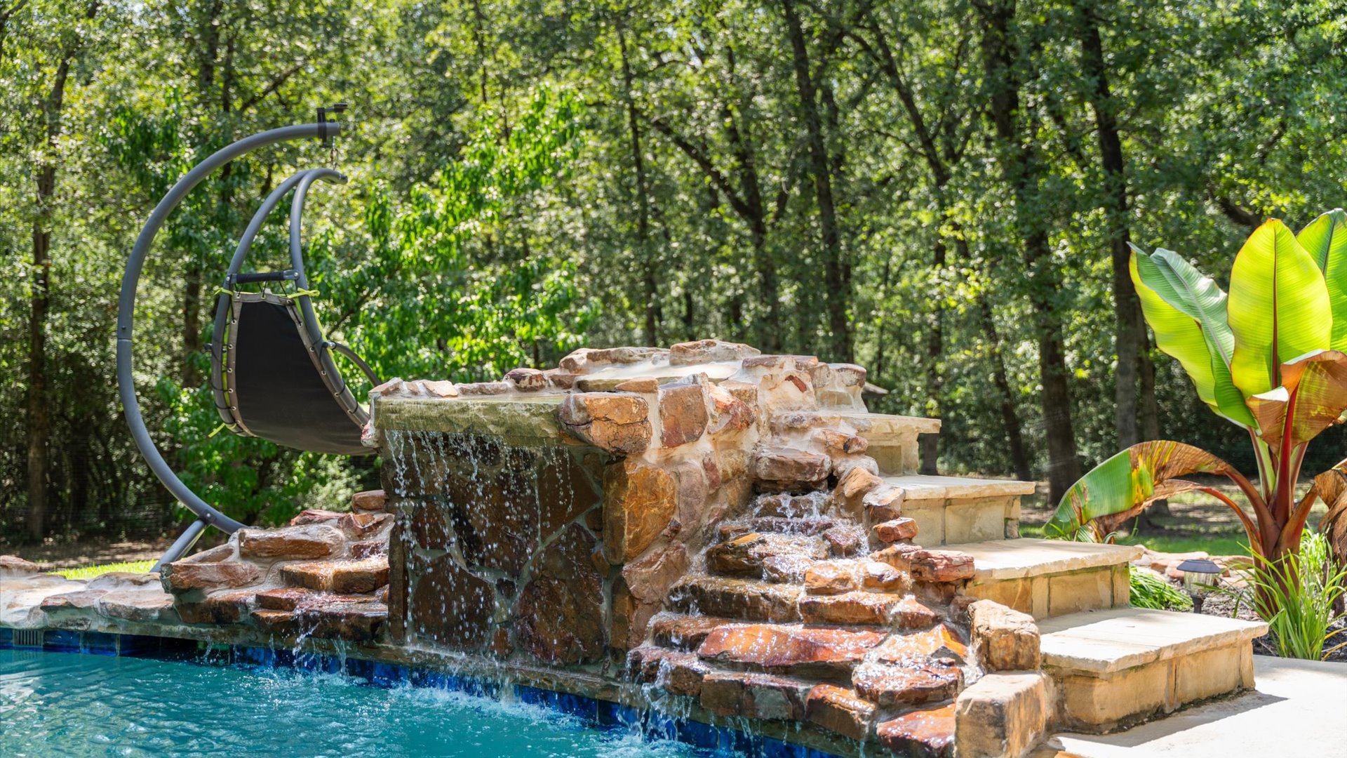 The pool features a built-in jumping rock—higher than a standard diving board—making it the perfect spot to show off your flips, tricks, or cannonballs.
