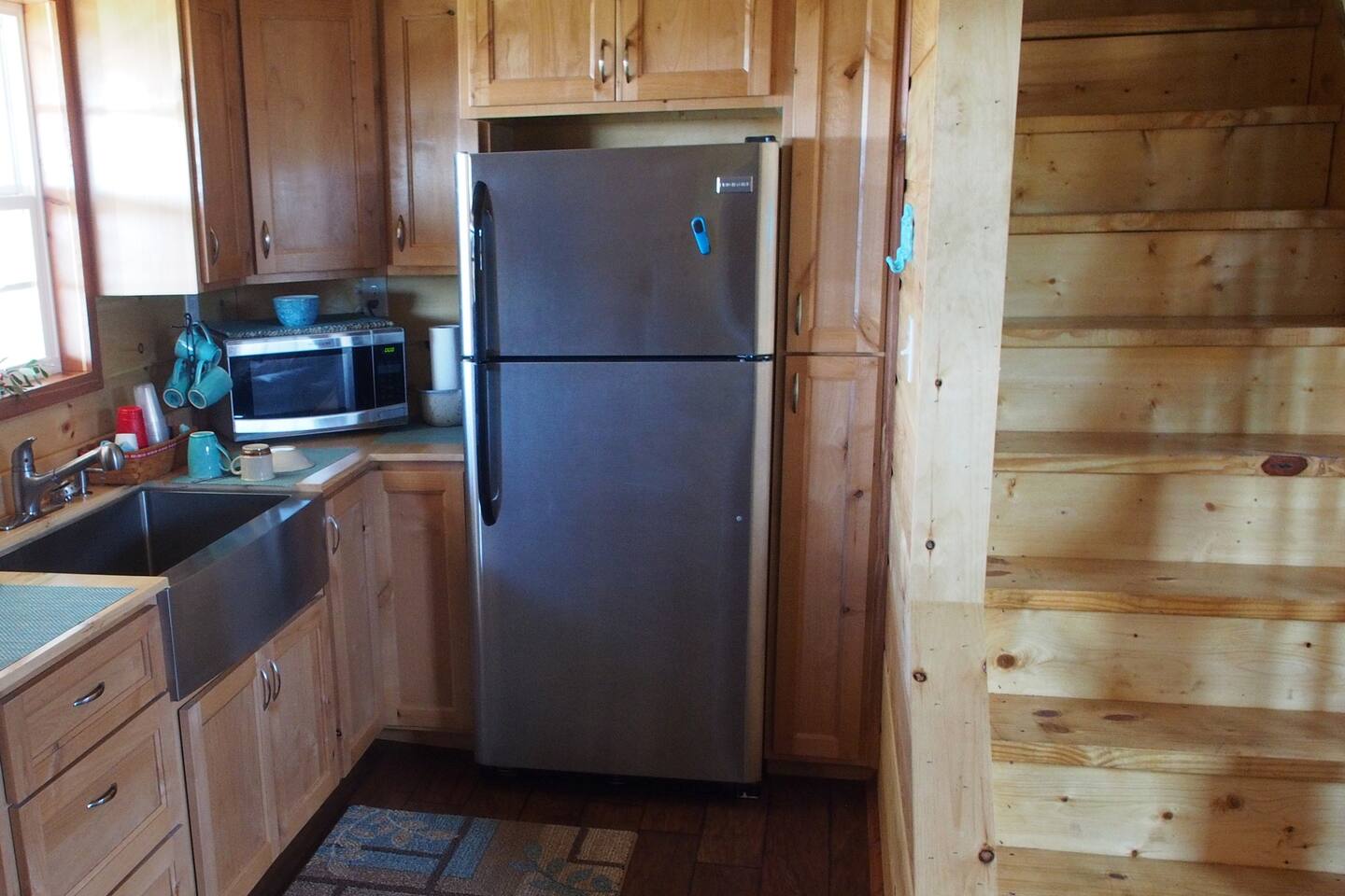 Expanded Kitchenette with Full-Sized Refrigerator Freezer with Ice Maker. Microwave, Stainless Steel Sink, Coffee Maker, and Coffee