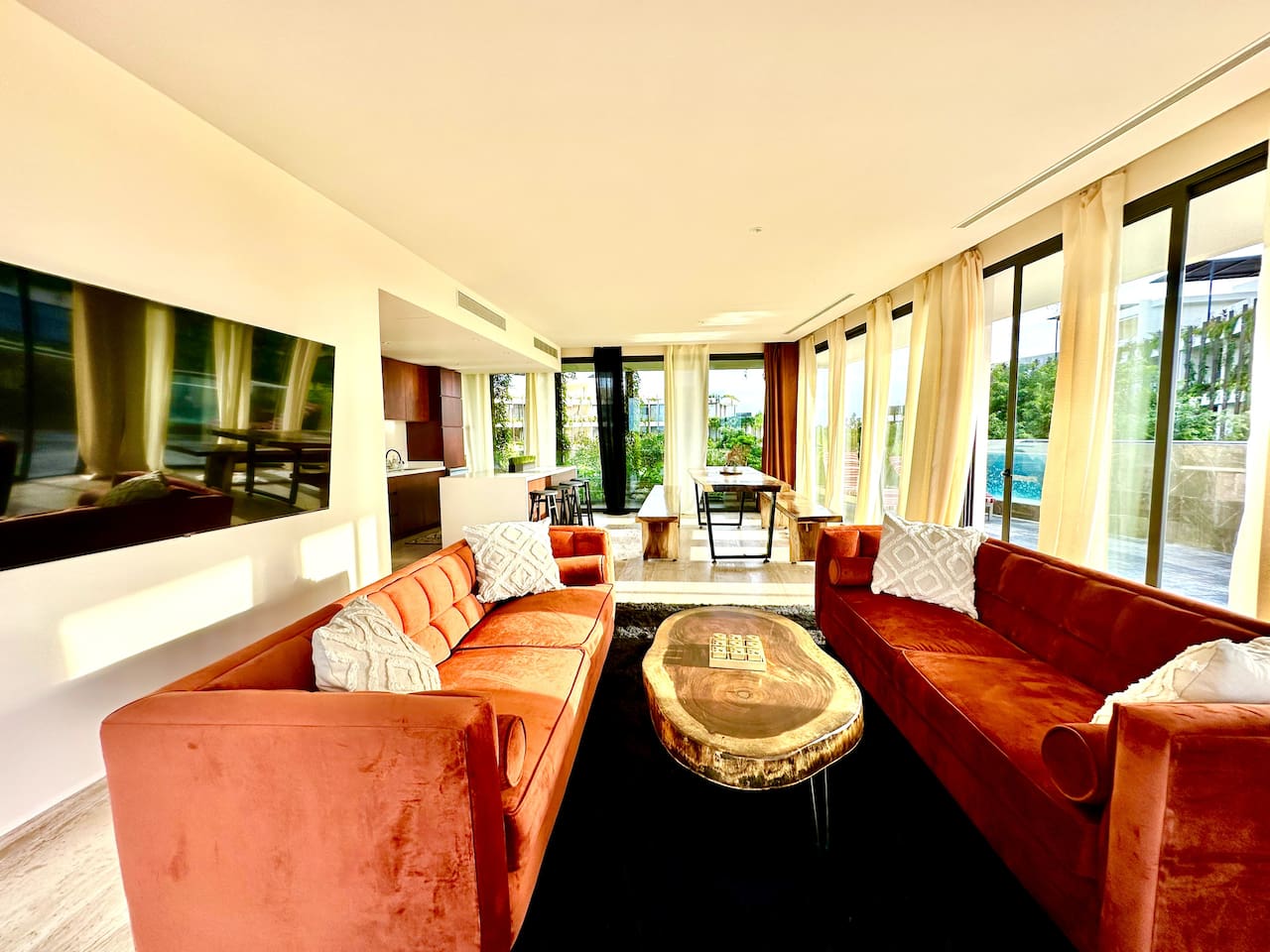 Living room with two central facing couches, and a flat screen TV