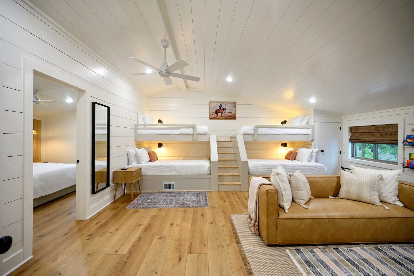 The ultimate bunk room for kids and adults alike - two queen and two twin beds, easy stair access to top bunks, and a modern leather couch for watching movies or just simply relaxing during your stay.