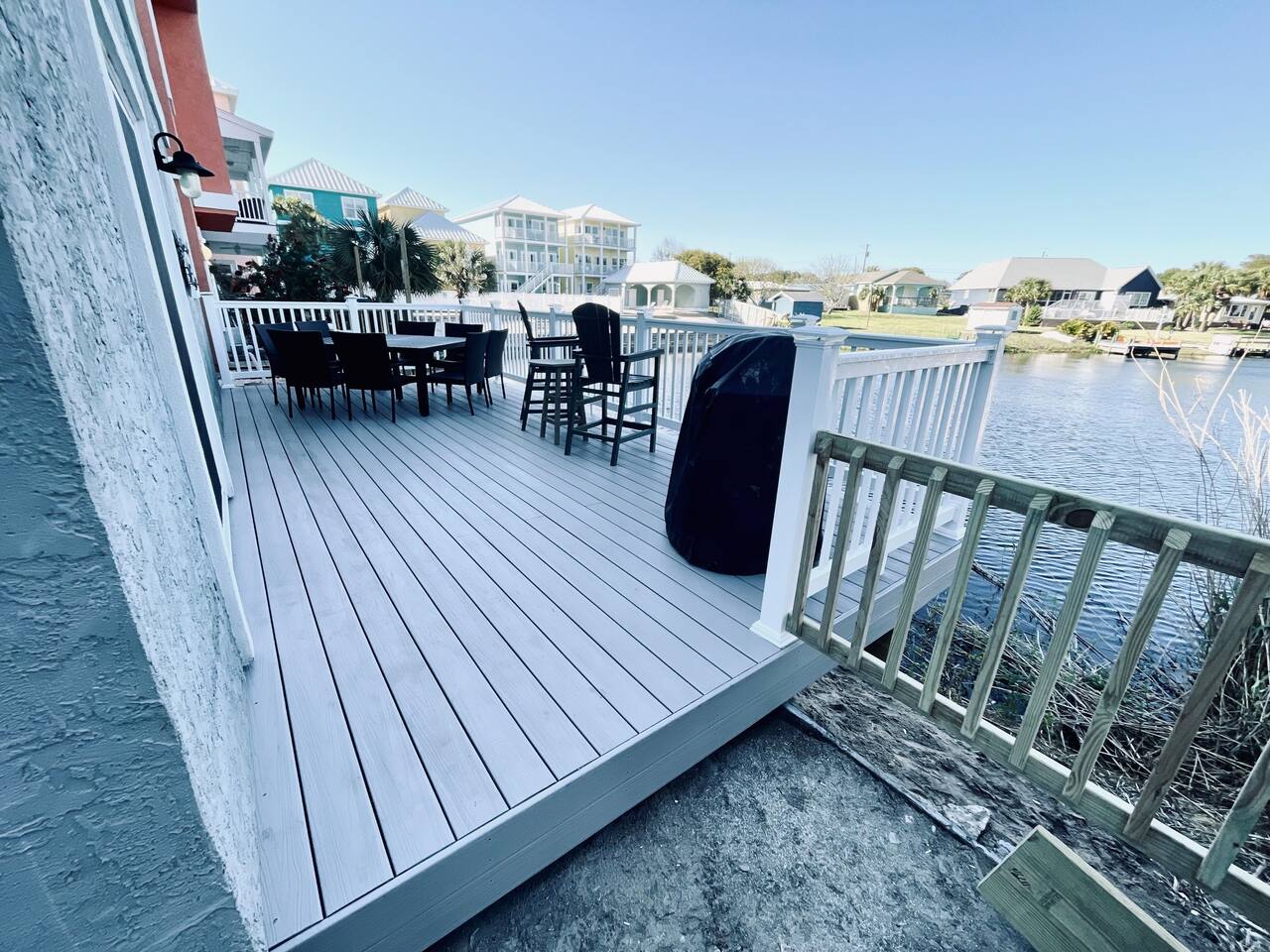 Our new larger 12x26 deck with grill, large table and chairs and extra chairs.