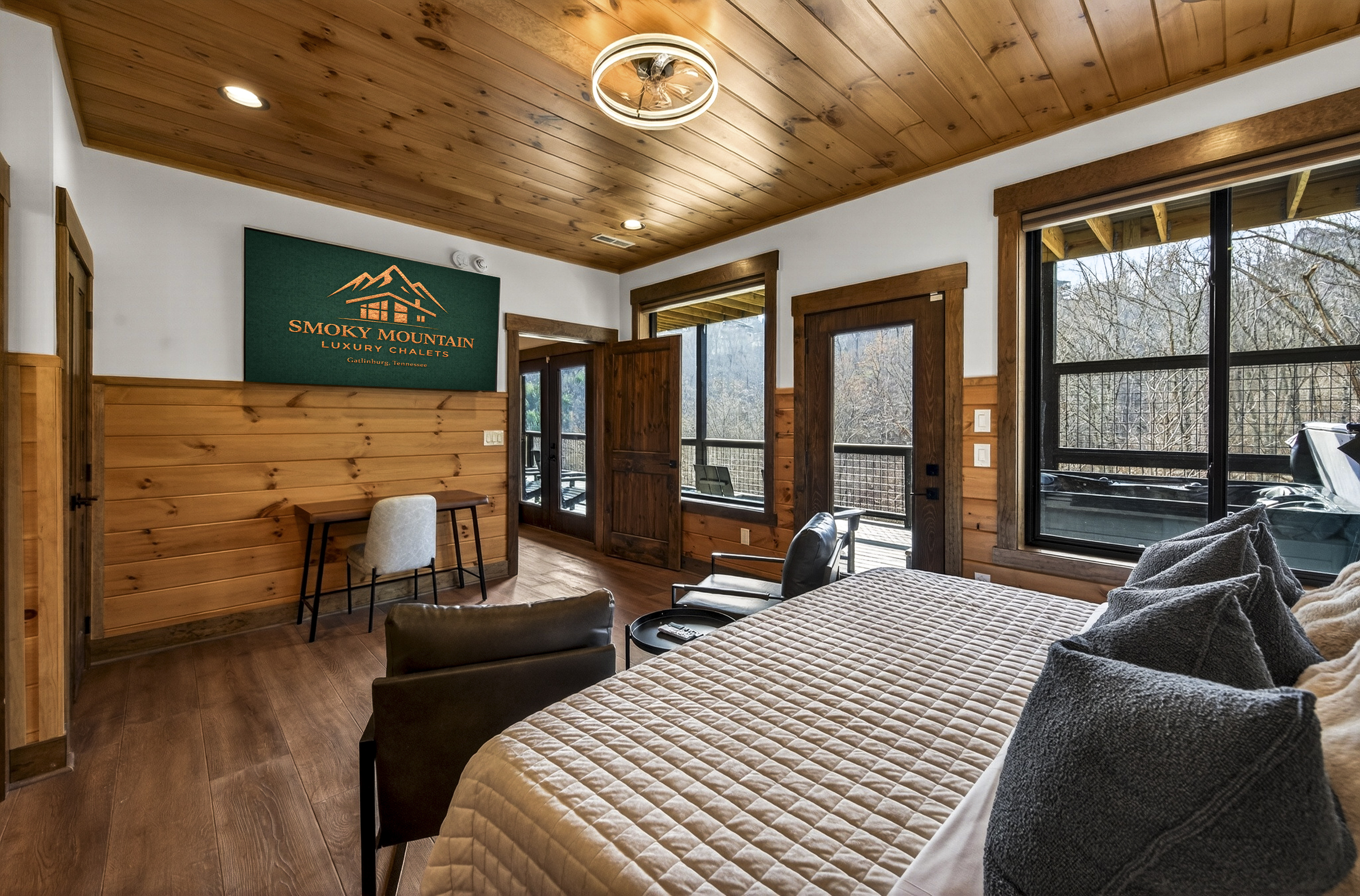 Relax in the spacious king bedroom with a large TV, dedicated desk workspace & direct deck hot tub access. Unwind in the en-suite bathroom featuring a walk-in shower with a natural river rock floor, bringing  the Smoky Mountains indoors for a spa retreat.