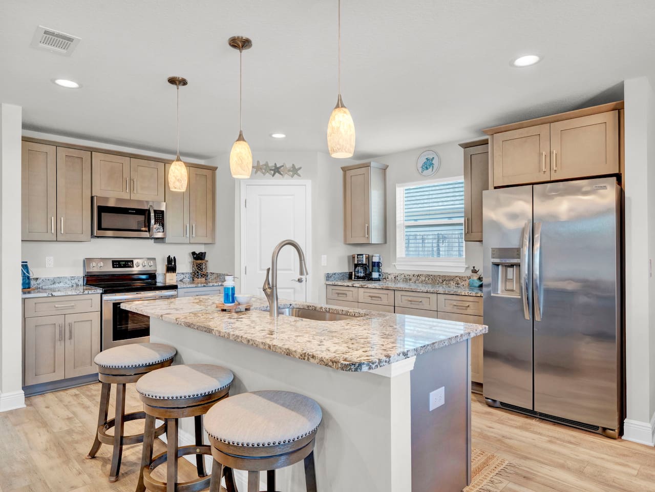Spacious Kitchen, Stocked with everything you need to make home cooked meals and pack for the beach, we even provide coolers for our guests to use.