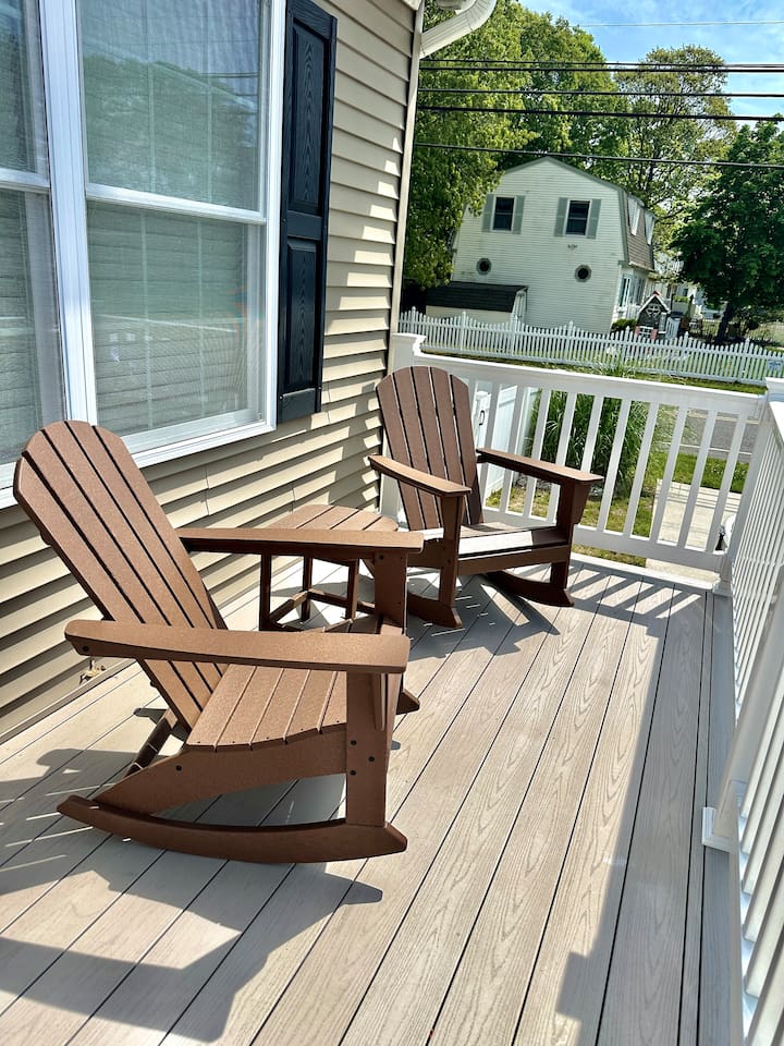 Settle into these classic rocking chairs for a relaxing view of the quiet neighborhood. This cozy front porch nook is a wonderful spot to enjoy a morning breeze or unwind with a book while the world slowly passes by.