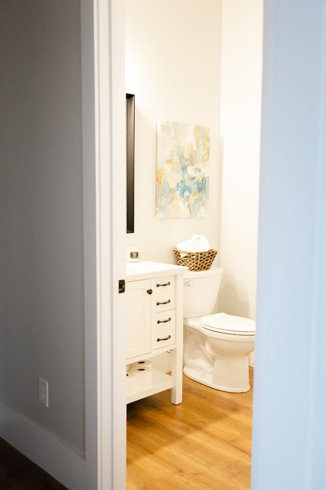 This full bathroom is located on the first floor at the hallway off the bottom of the main staircase. It includes a bathtub with shower. 