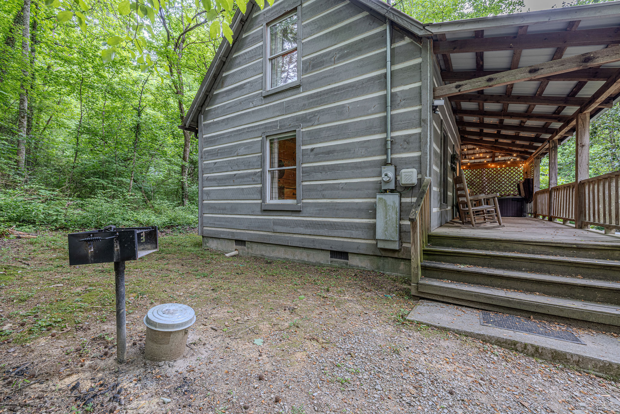 Tucked into the trees with a long covered porch.