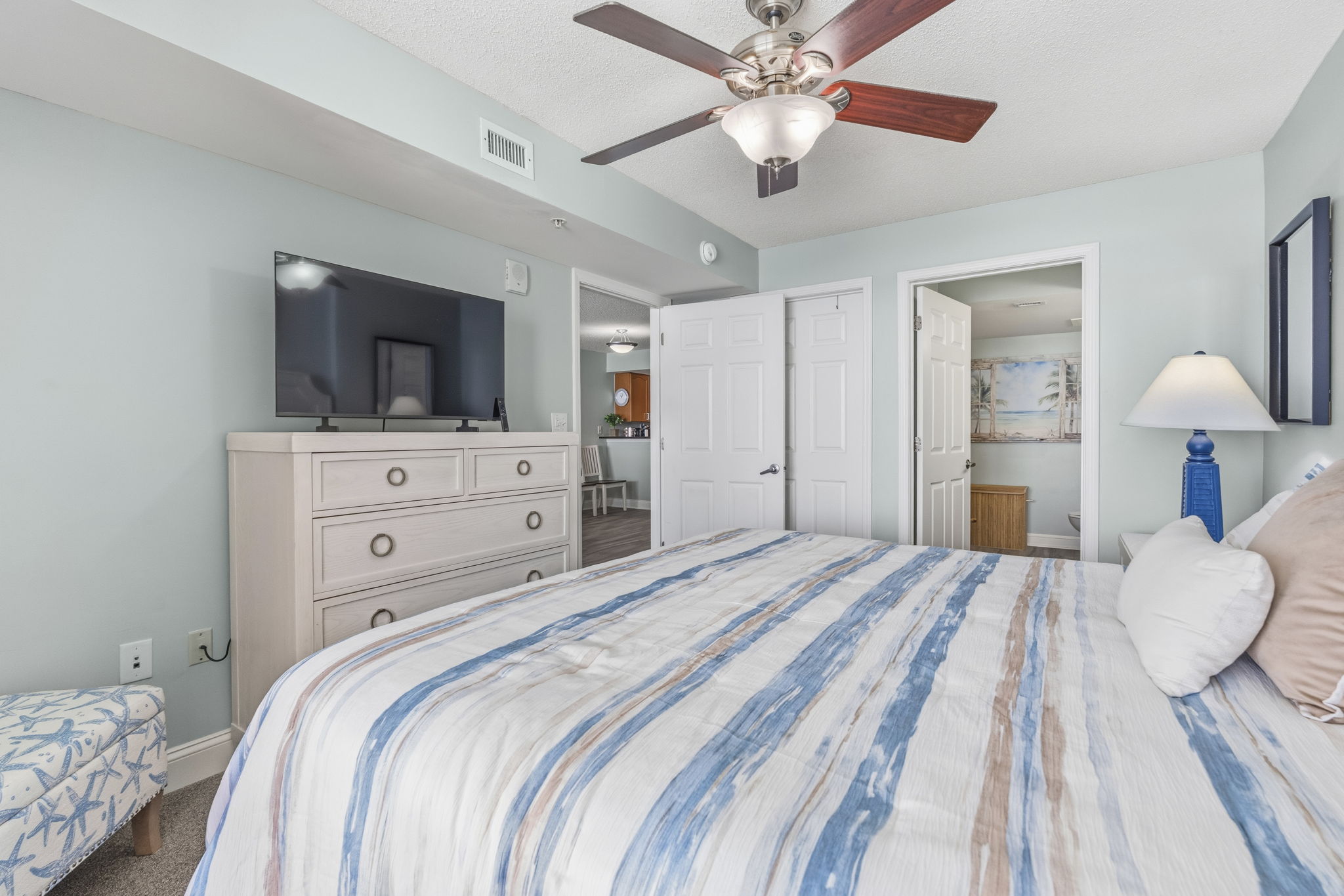 Primary Bedroom with King Bed, ensuite bathroom, and balcony with direct oceanview