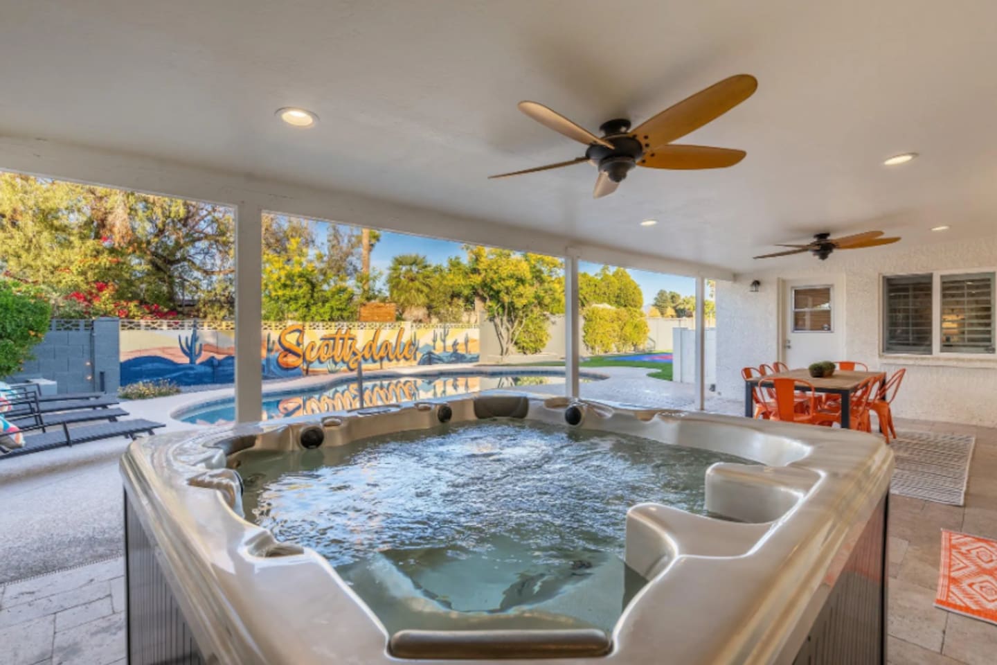 Soak away the day in the private hot tub, tucked under a shaded patio with ceiling fans keeping things comfortable even in the Arizona heat. The mural in the background says it best: this is Scottsdale.

