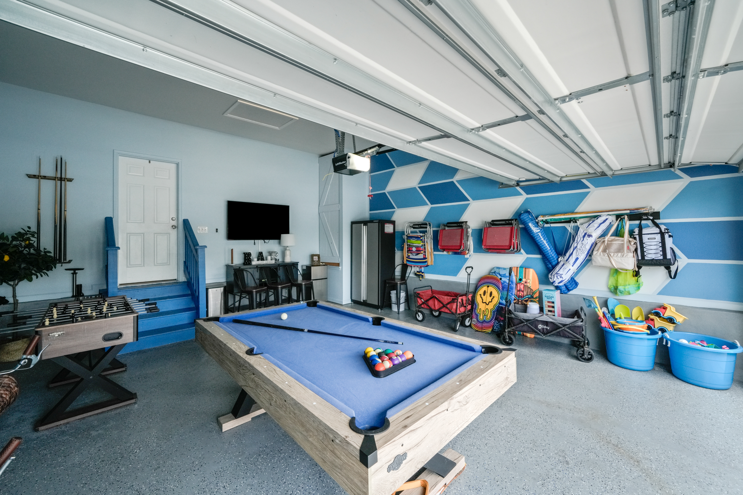 Game on in this mini pool table, Foosball and mini bar in the garage