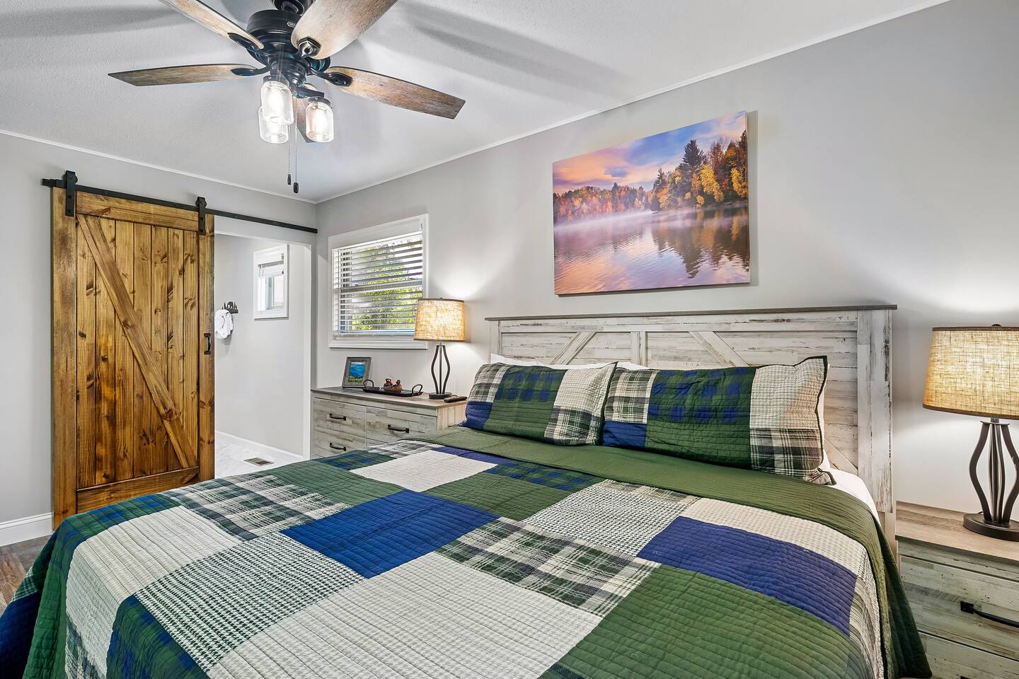 Dream in rustic luxury! Our master suite blends mountain charm with modern comfort. Sink into the plush king bed, admire the serene lake artwork, and wake refreshed for Smoky Mountain explorations.
