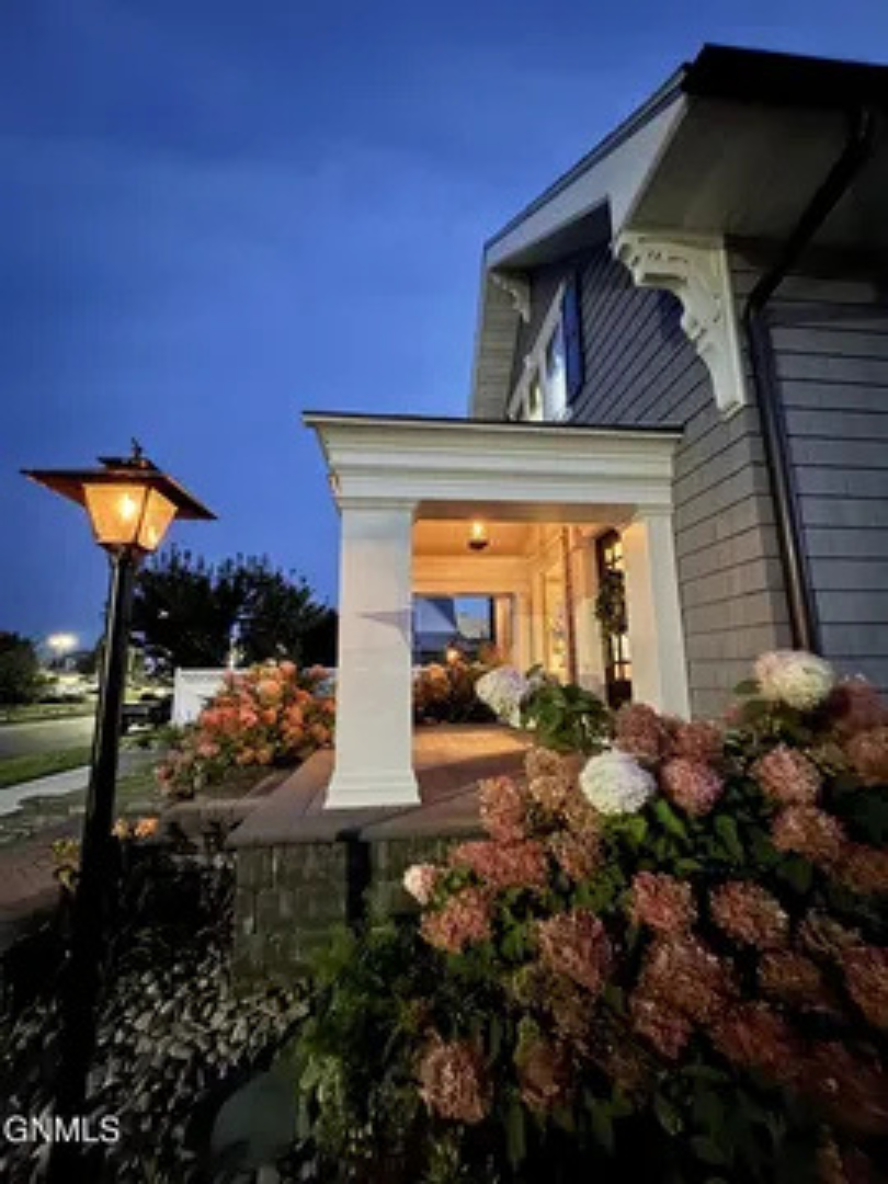 A charming covered porch with soft lighting that makes coming home feel extra nice.