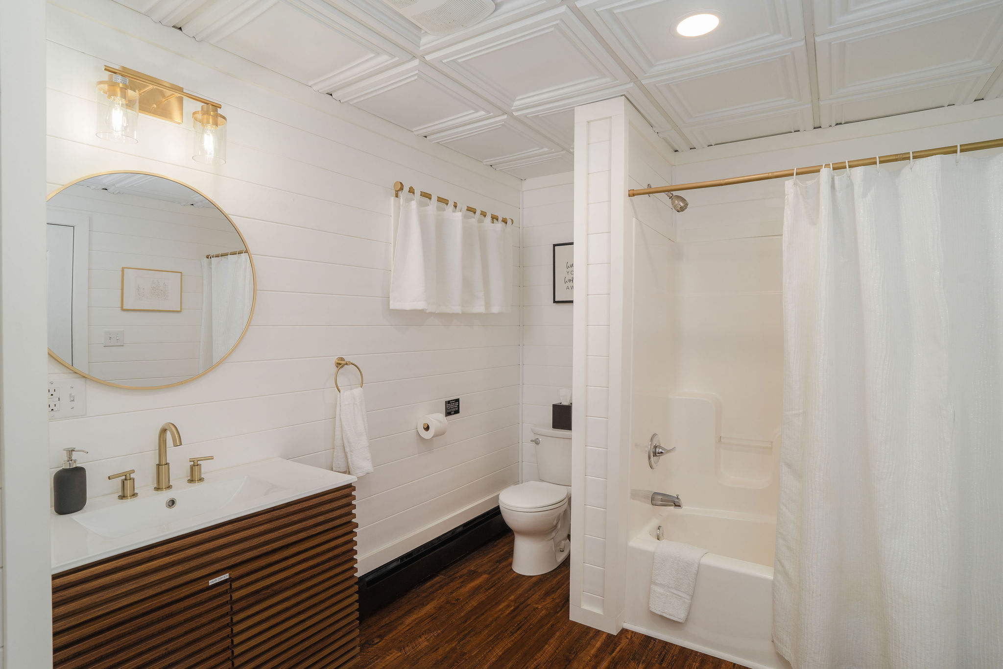 Bright & modern full bathroom with spacious vanity, tub/shower combo, and fresh towels for your stay.