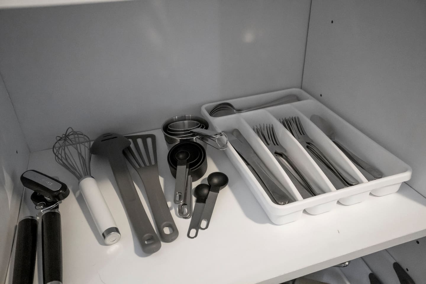 Additional cooking utensils and silverware are provided for guests, ensuring everything needed for preparing and enjoying meals is at your fingertips.