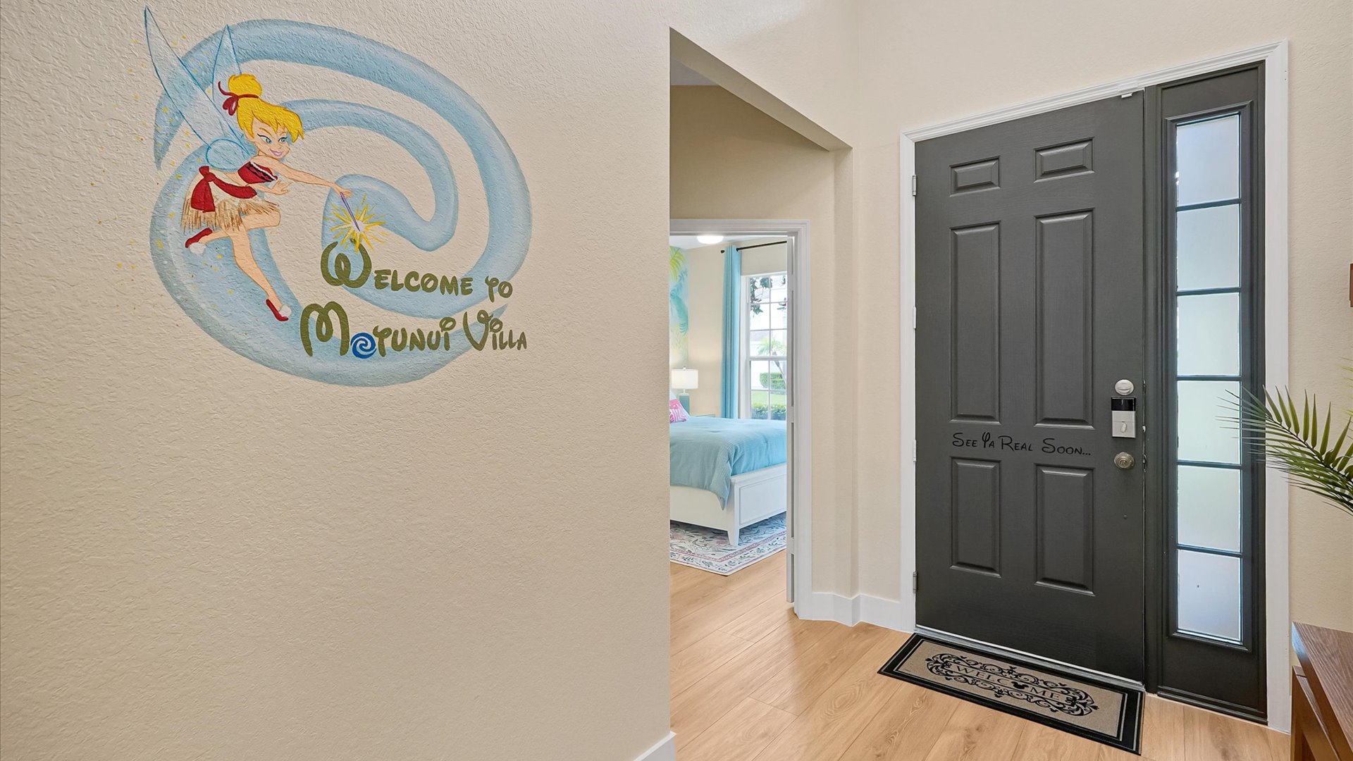 Front Entryway: Welcoming entrance to Motunui Villa featuring a custom mural of Tinker Bell dressed as Moana.