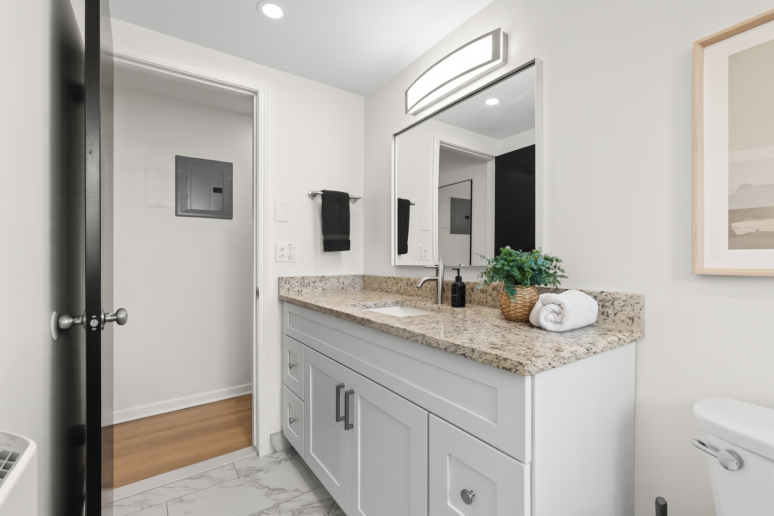 Stylish bathroom with granite countertops, fresh towels, and thoughtful touches to make you feel at home.