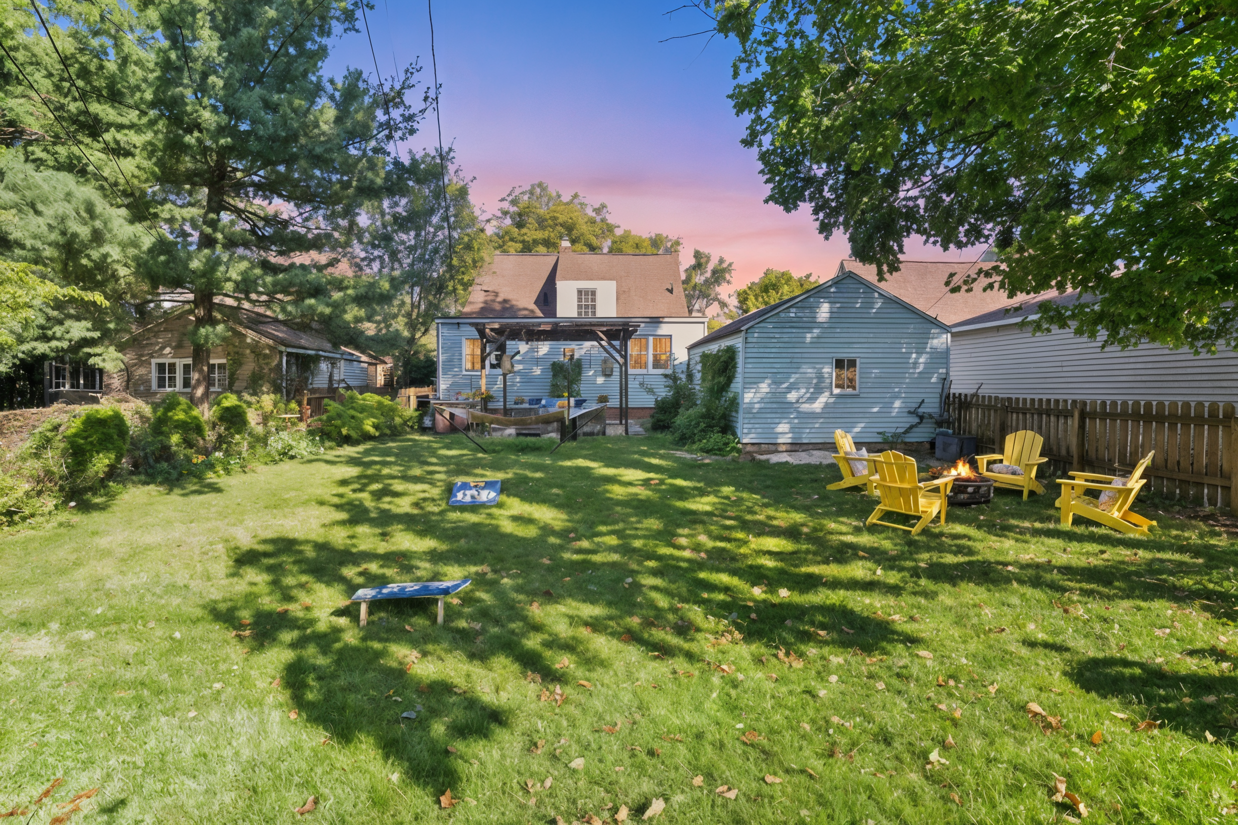 Flat green grass, full privacy, and family-friendly fun—our fenced South Bend backyard features cornhole, a pergola, fire pit, grill station, and hammock for alfresco relaxation.