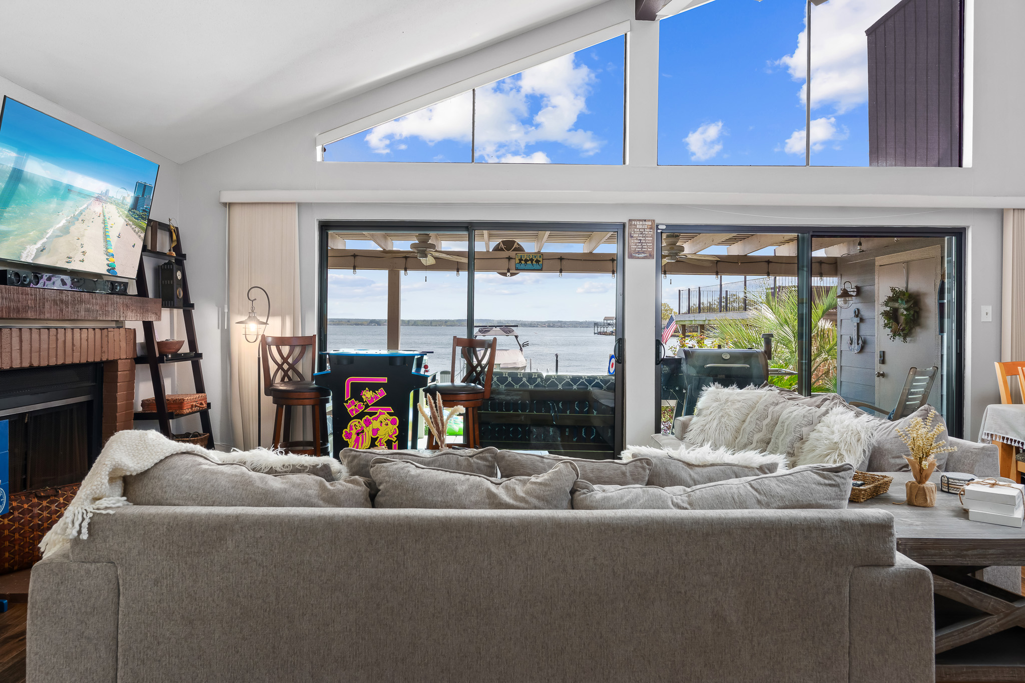Soak in panoramic lake views from the comfort of the plush living room—your peaceful retreat awaits just beyond the glass doors.