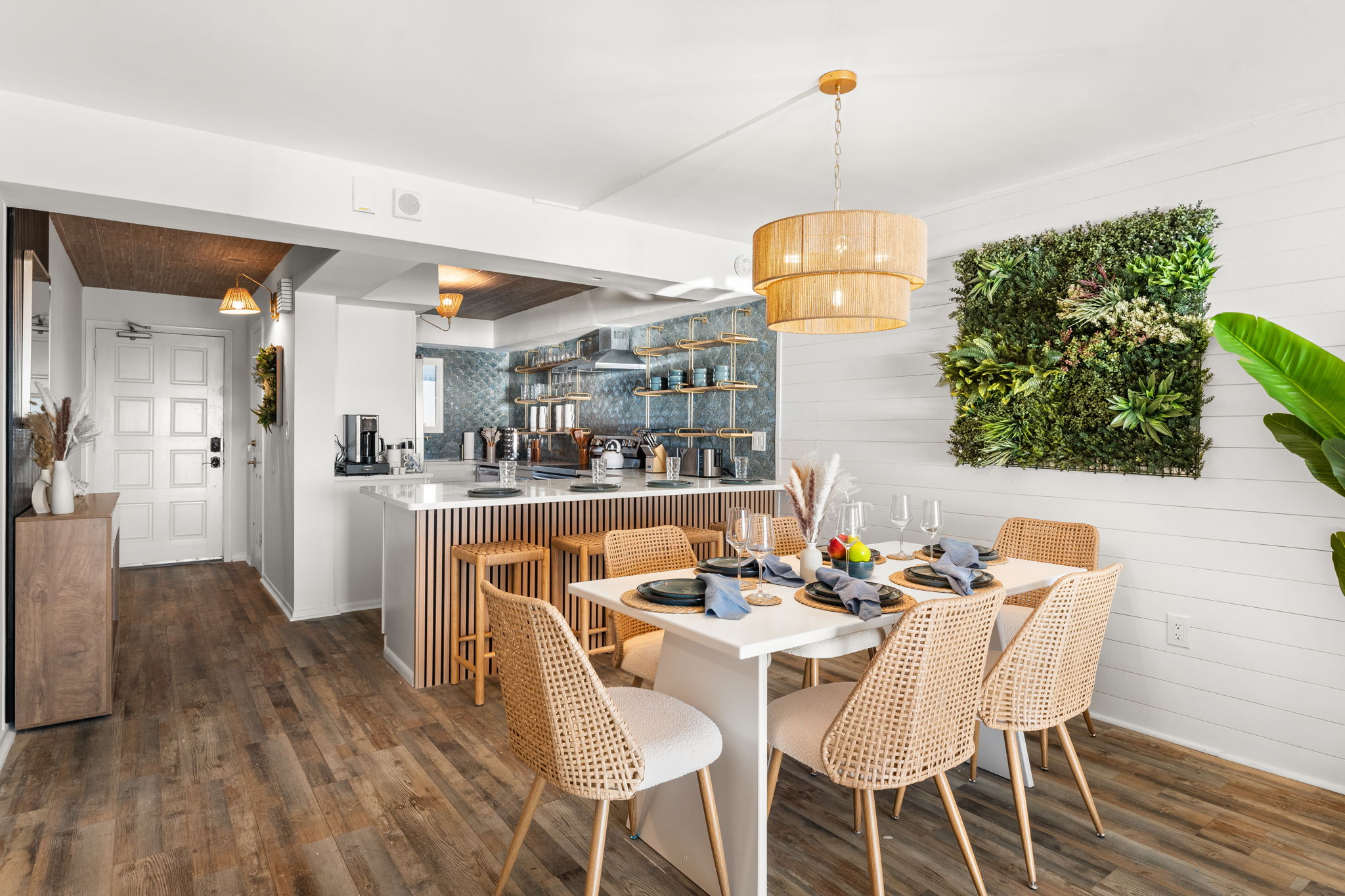 Tropical wall decor and relaxed boho lighting set off the coastal design