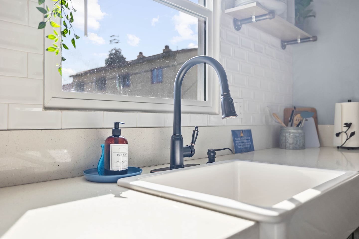A featuring a stylish sink and sleek faucet, complemented by a decorative hand soap dispenser. This functional setup enhances the kitchen's aesthetic, creating a clean and inviting space for cooking and meal prep. Perfect for your culinary adventures