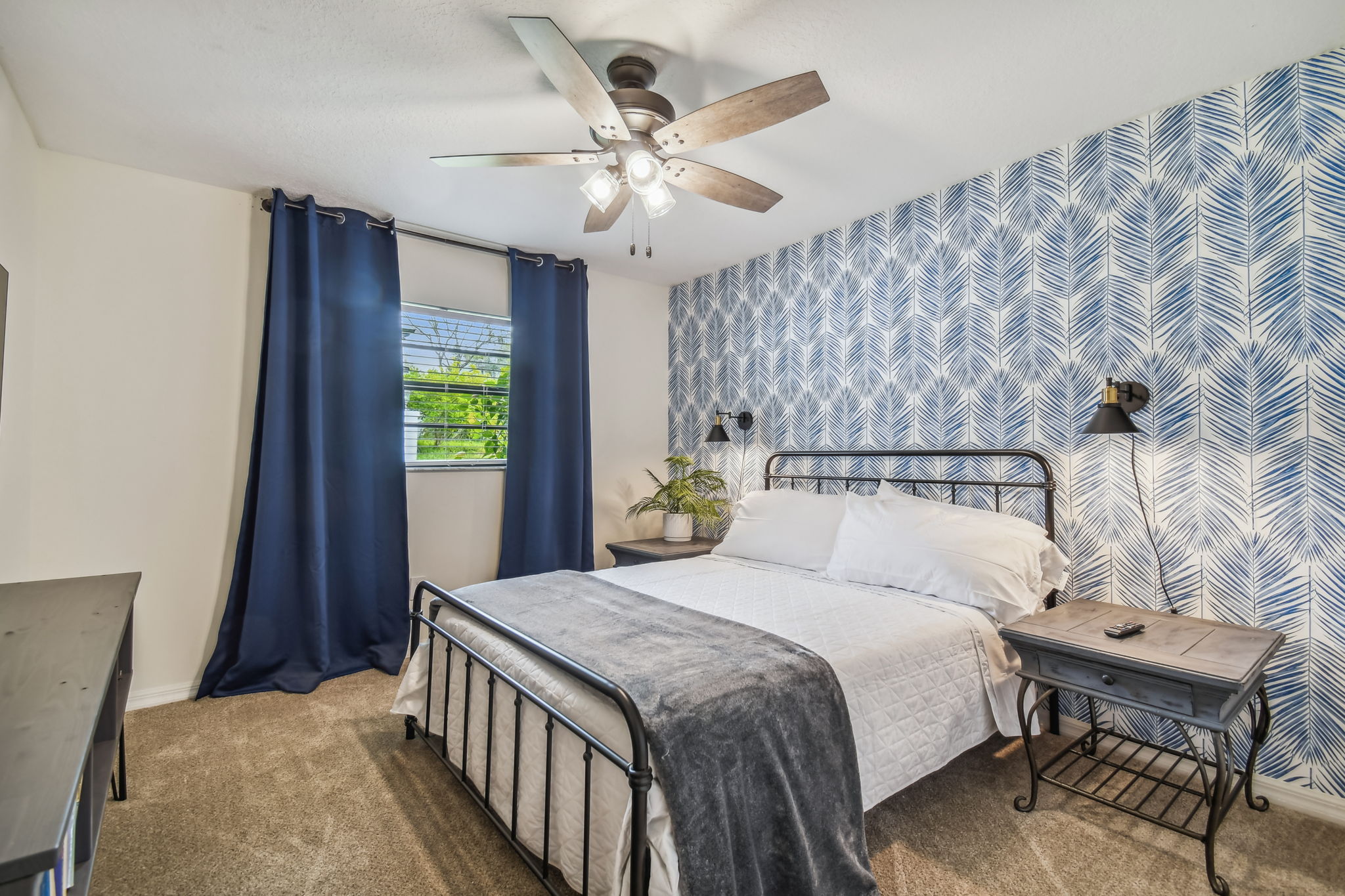 The Blue Palm Bedroom features a queen bed, full closet, blackout curtains, and 50" smart TV.