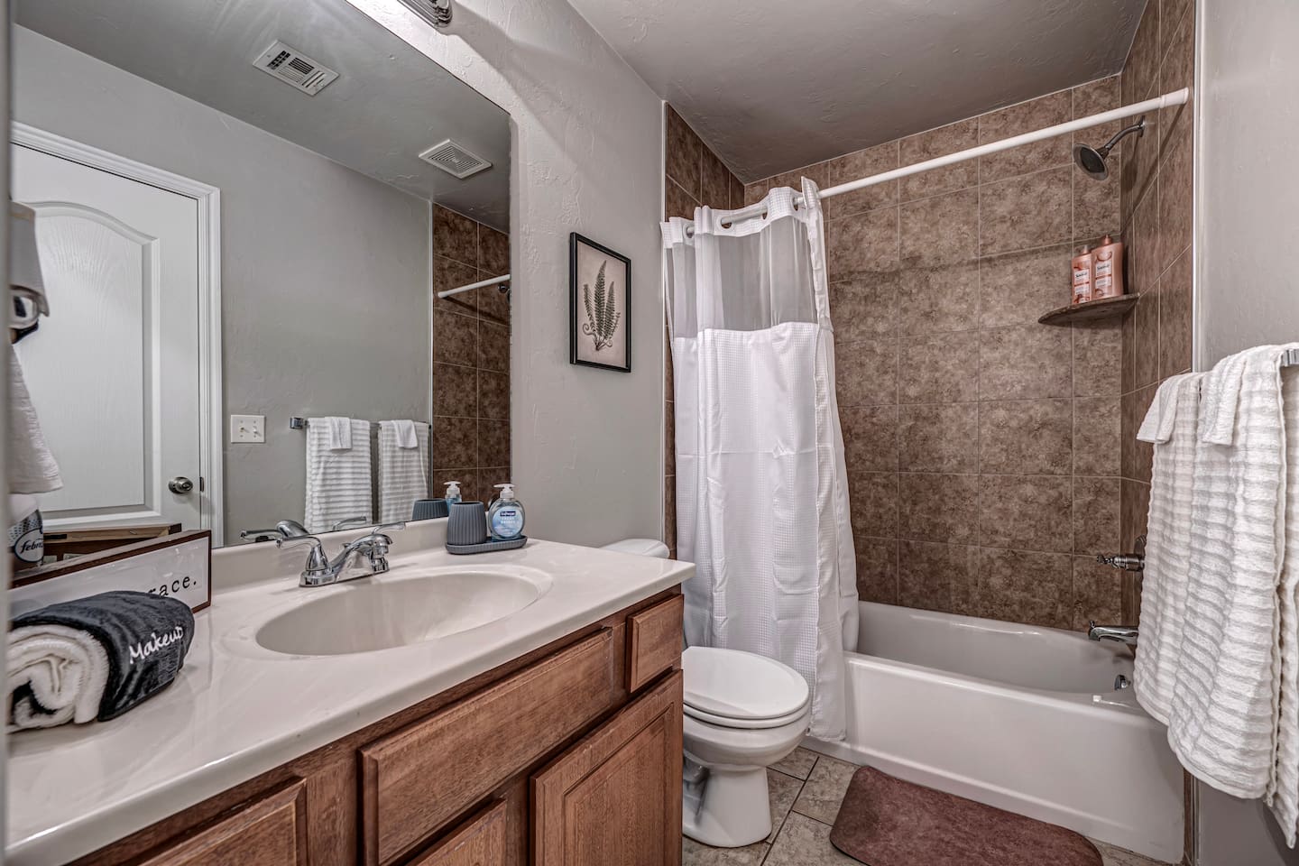 Fresh and clean master bathroom featuring a shower/tub for your comfort.