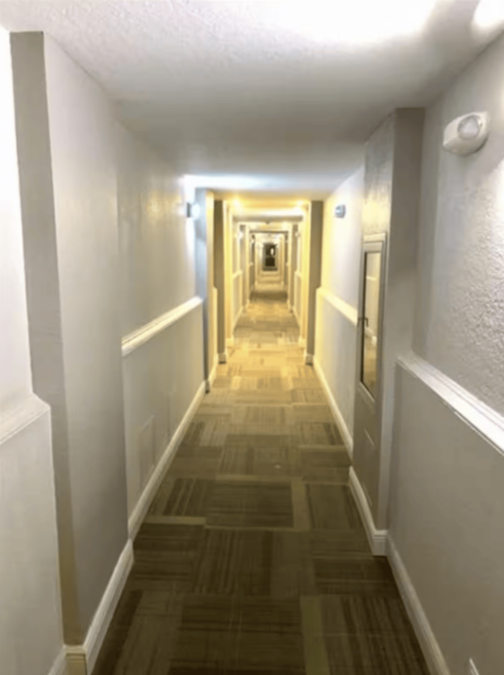The interior hallway leading to the condo unit.
