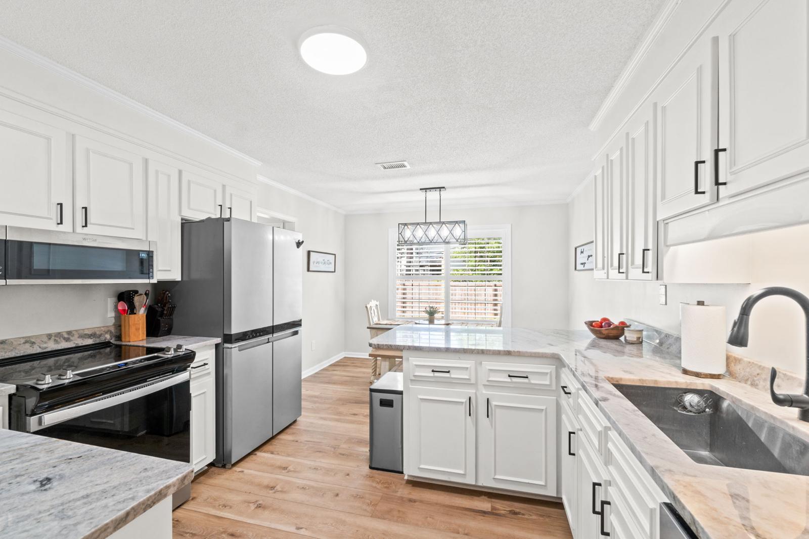 Kitchen with bar seating and all appliances