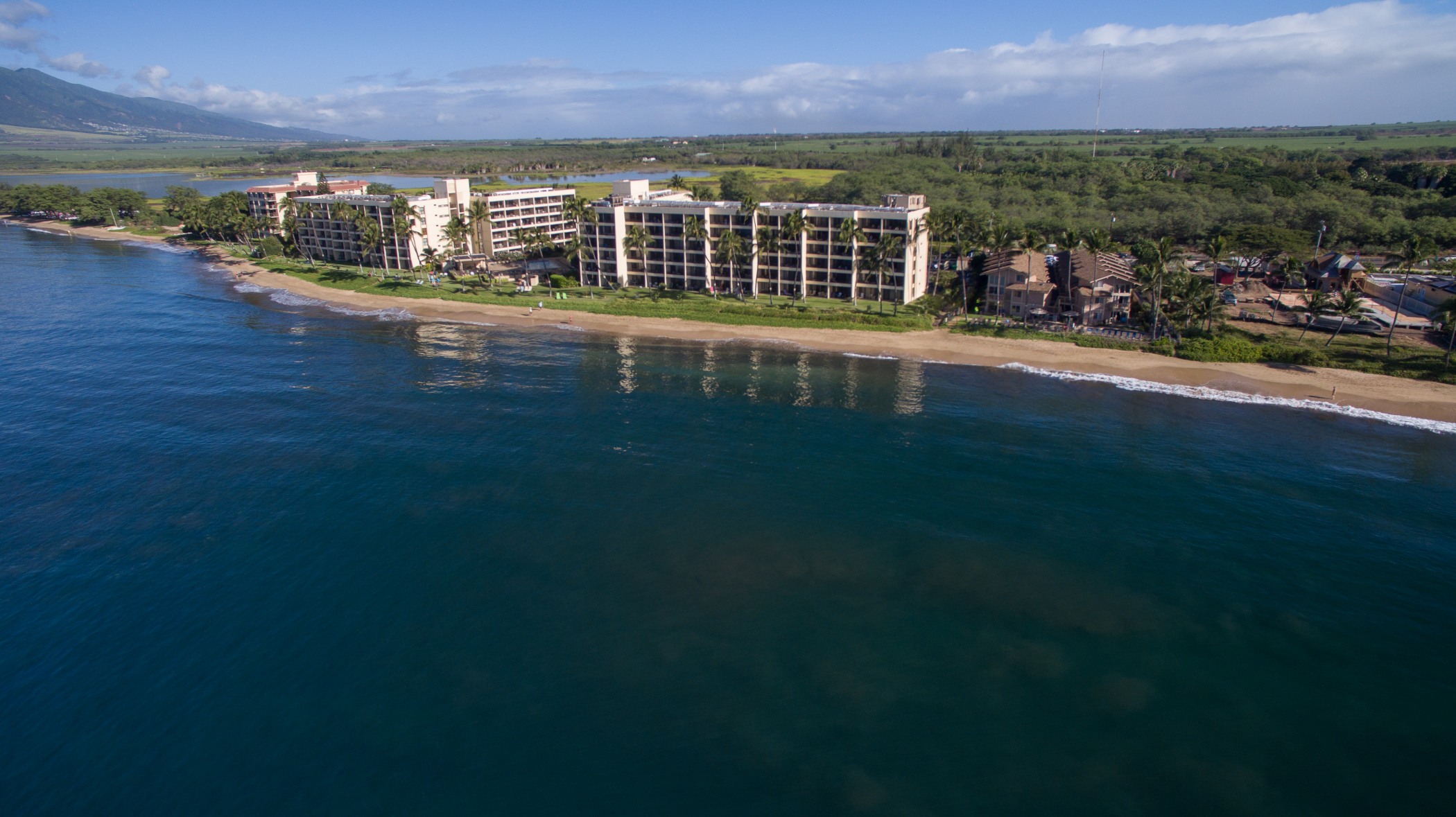 Aerial view of Sugar Beach Resort, the 5 mile beach and surrounding wetlands