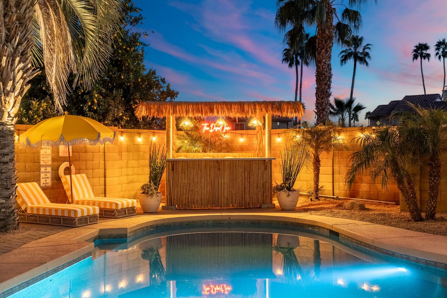 Twilight view of pool and cabana.