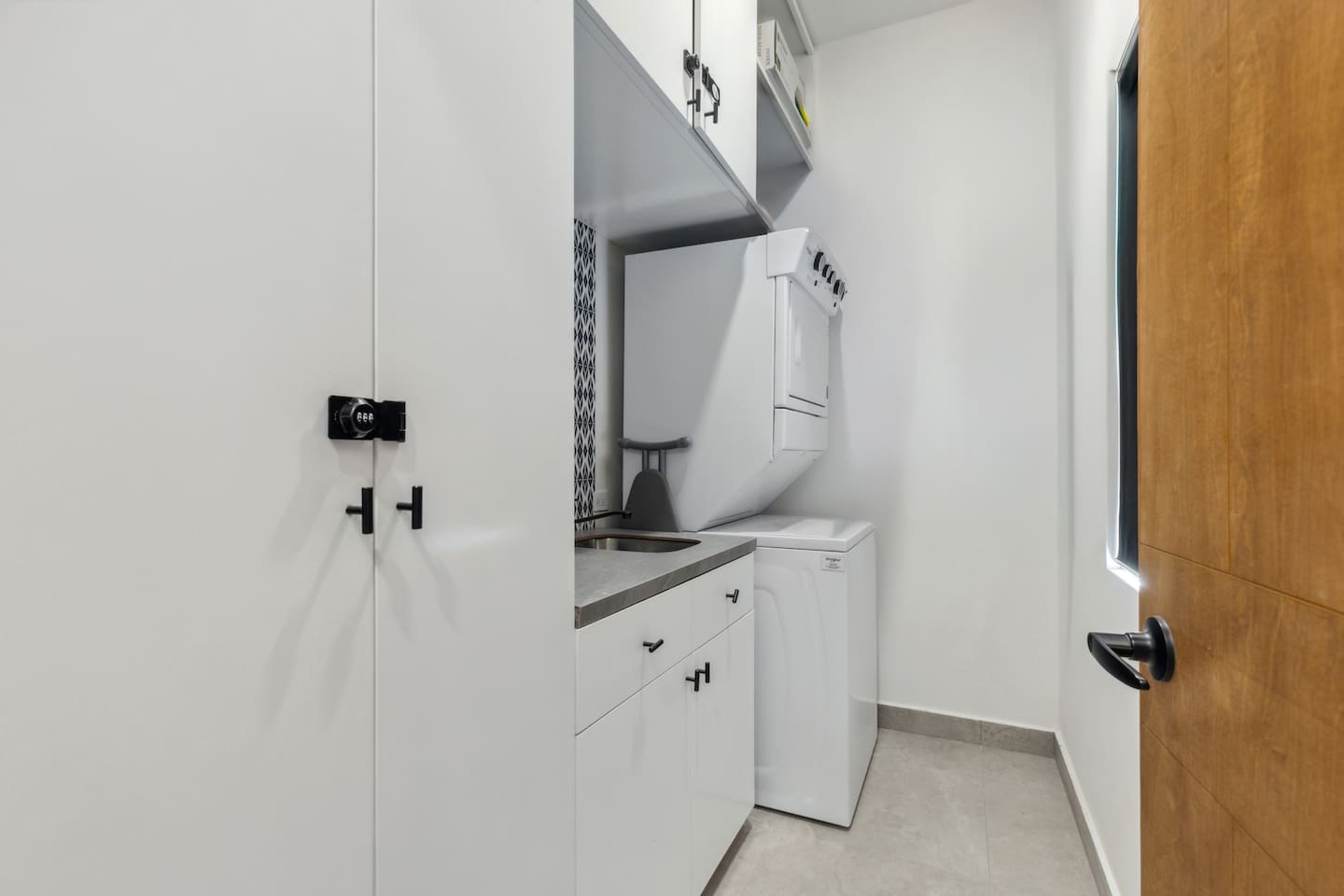 Enjoy the convenience of a custom laundry room in Cabo, featuring stackable washer and dryer units, plus all essentials for washing clothes—detergent and an ironing board. Perfect for a hassle-free stay.