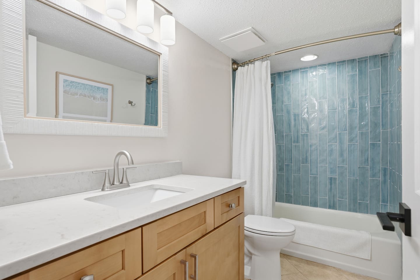 Guest Hall bath has a tiled shower with tub