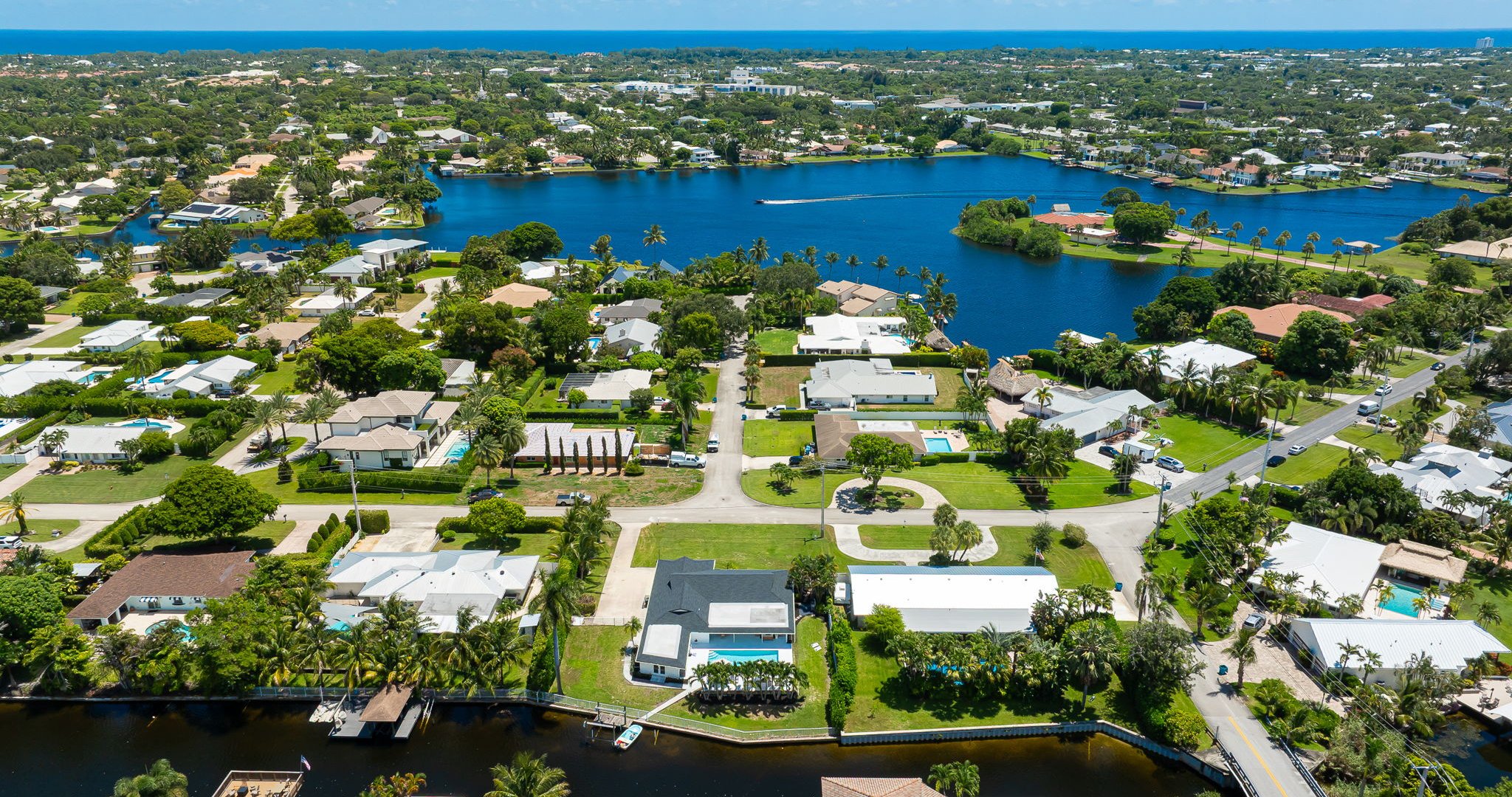 This stunning home sits along a private canal with direct access to Lake Ida, offering a true waterfront retreat. From above, you can see the sparkling pool, lush landscaping, and serene neighborhood that make this property ideal for families and groups.