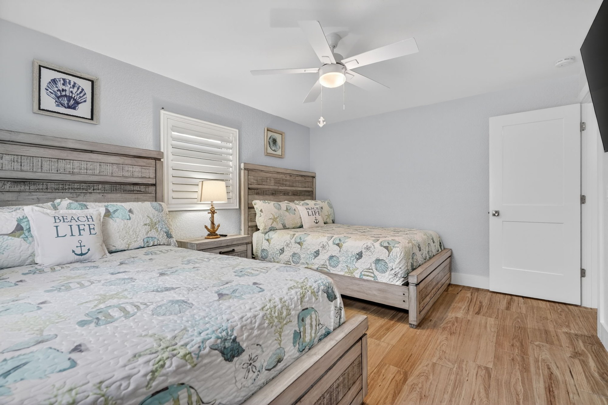 Bedroom with beach-themed bedspread, second view