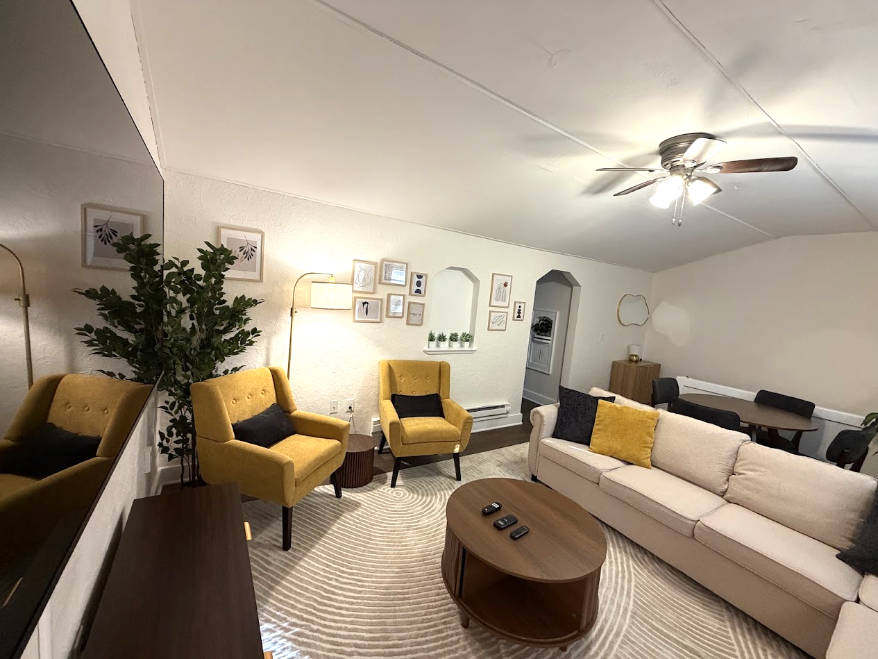 Living Area w/ 65" Smart TV and pull-out sofa bed