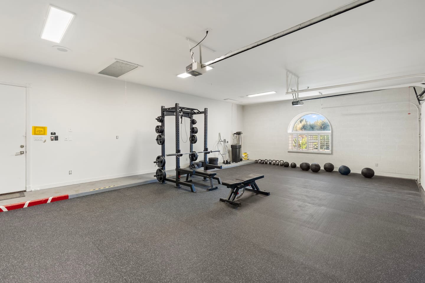 Stretch, sweat, and strengthen with ample room to move—this garage-converted gym is ideal for high-intensity or low-impact sessions.

