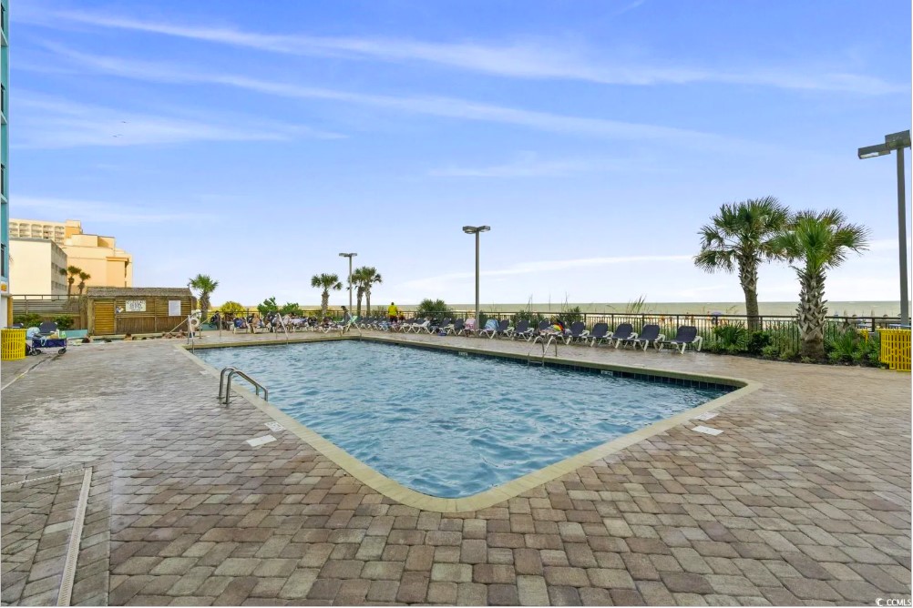 Behold the breathtaking view, where the azure waters of the pool seamlessly blend with the vast expanse of the ocean, creating a true seaside paradise.