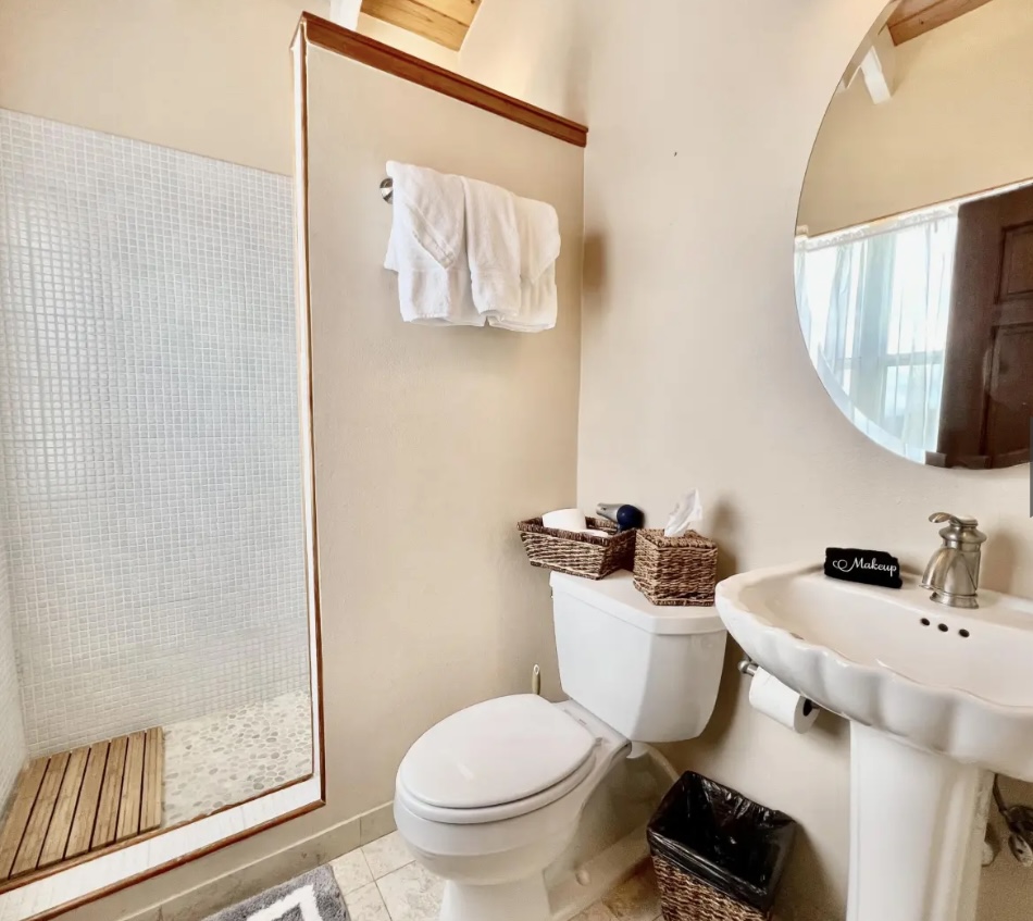 Fresh, coastal-style bath with plush towels and thoughtful touches for a spa-like feel.