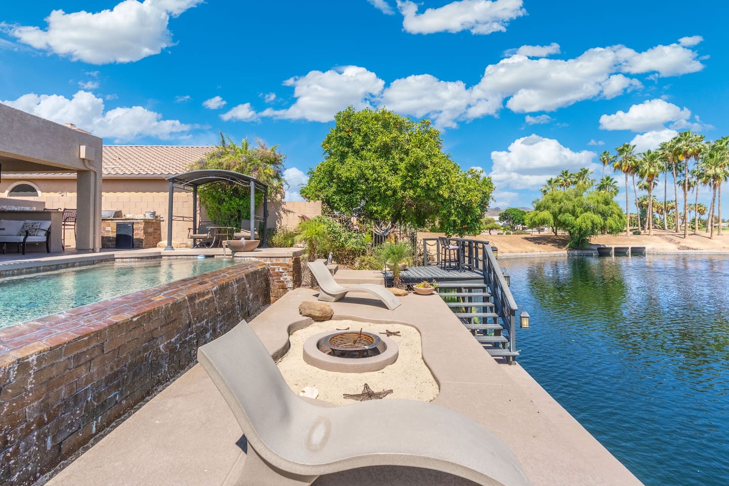 The lakeside terrace puts you right at the water's edge — stretch out on the sun loungers, light the fire pit, and watch the world drift by from your own private slice of paradise.