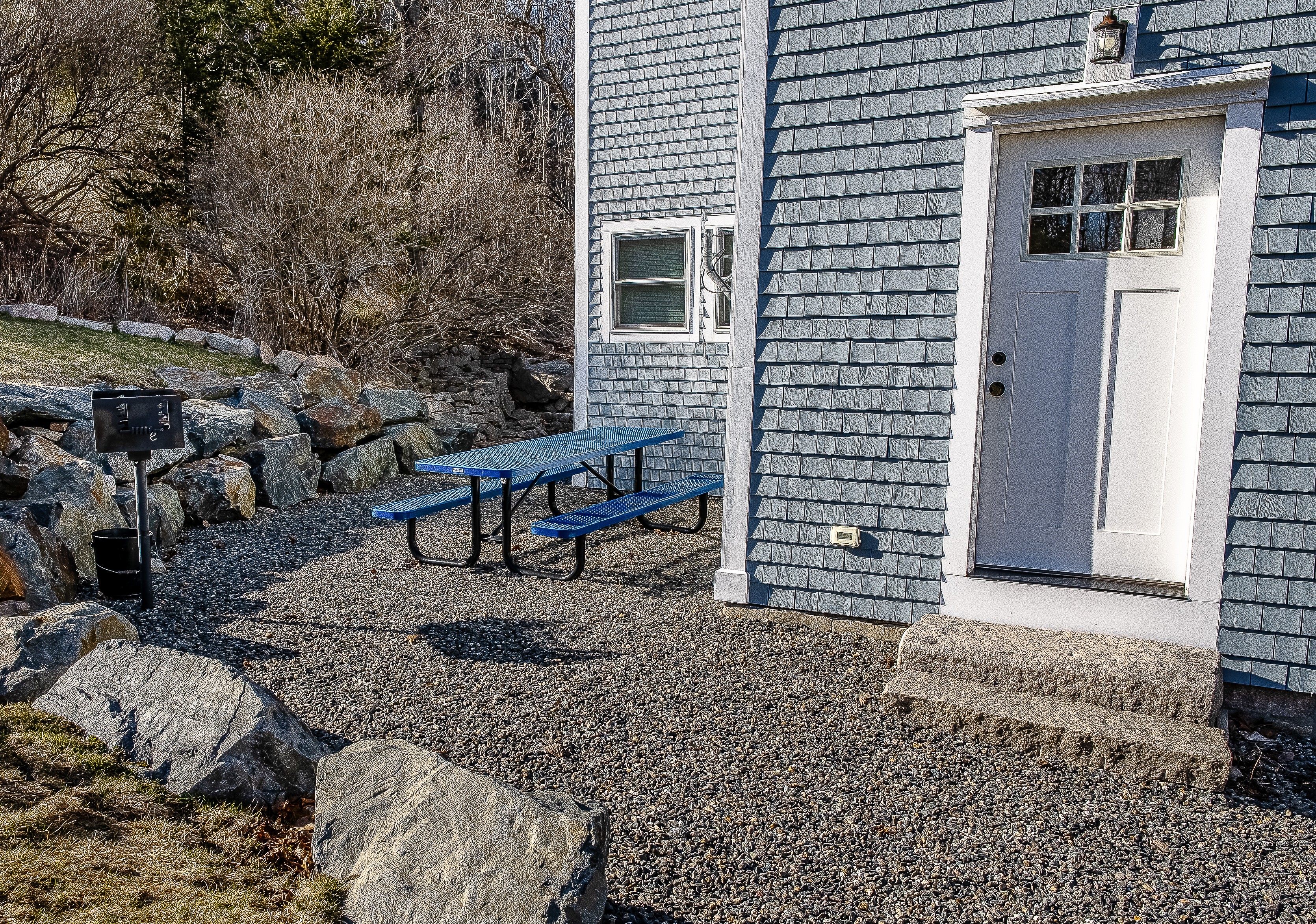 The outdoor grill area is just steps from the kitchen door, making it easy to prep and serve your favorite trailside meals. This convenient setup, framed by Maine granite, ensures you spend less time in the kitchen and more time enjoying the island air.