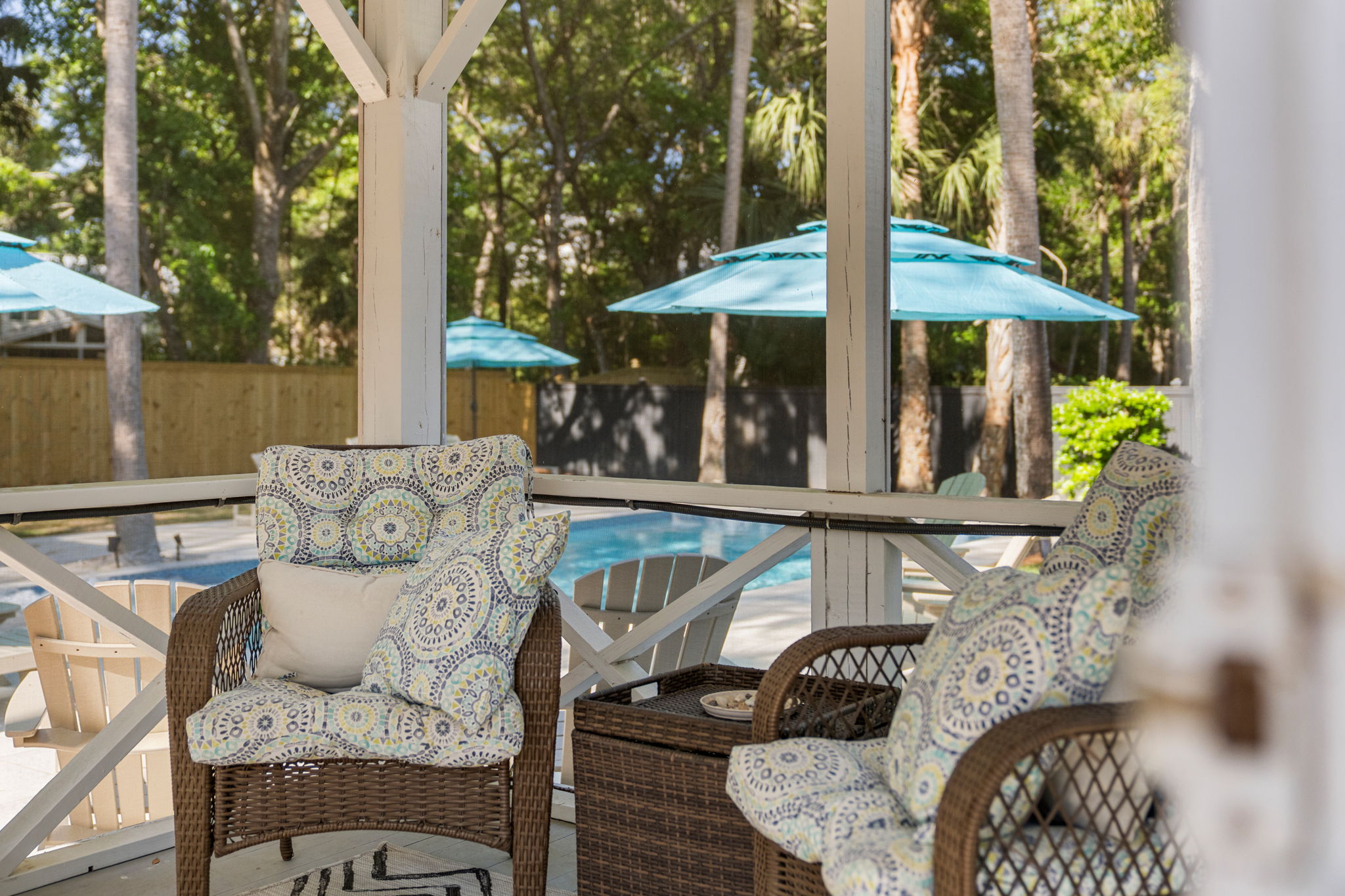 Screened porch is a great place to enjoy a book or relax in the evening to the sounds of the ocean | IOP Escapes Beach Blessing | 3705 Hartnett Blvd, Isle of Palms, SC