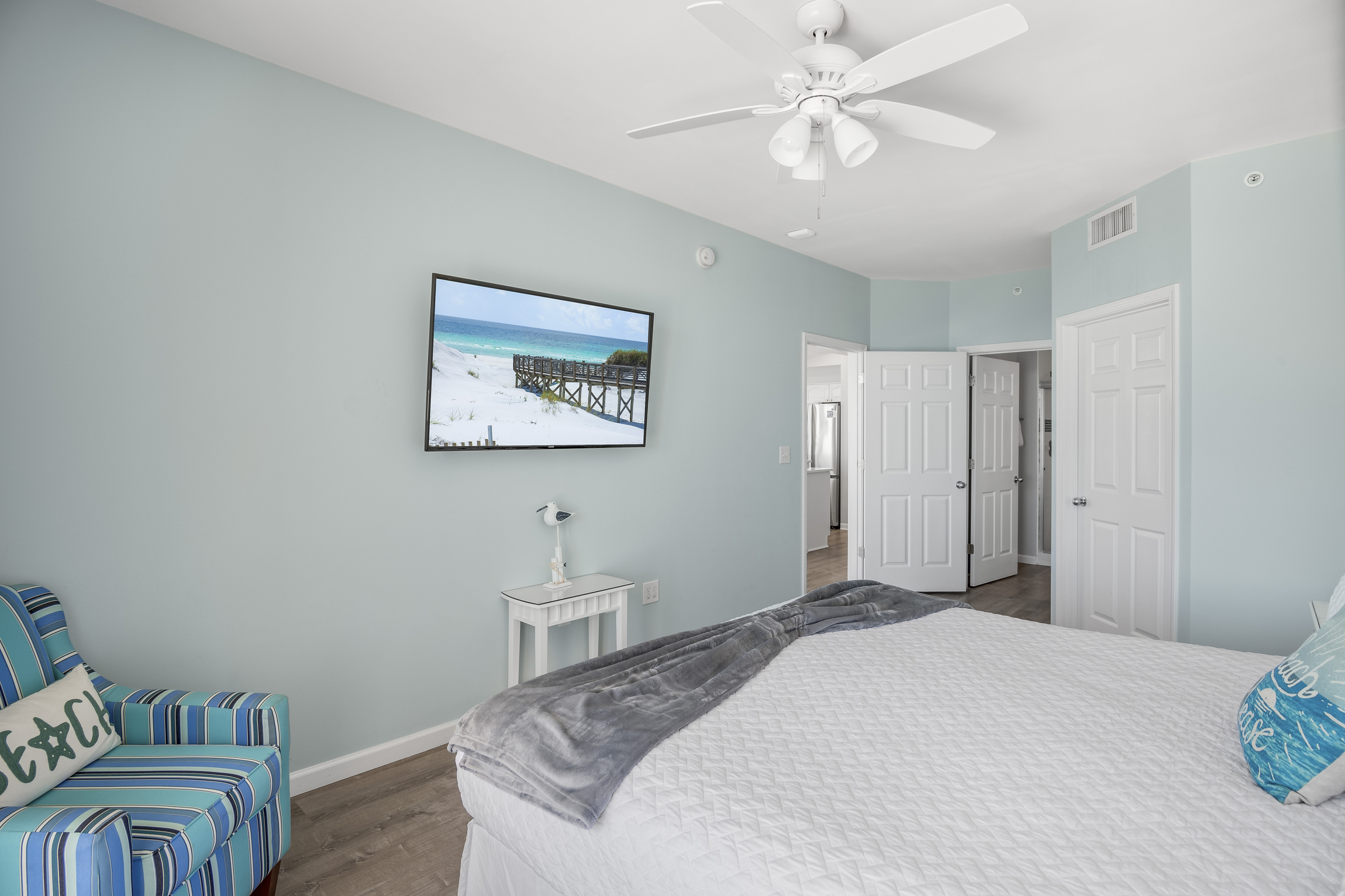 Spacious master bedroom features a King bed, Gulf views, balcony access, SMART TV w/ cable access, remodeled bathroom with walk in shower, and large closet.