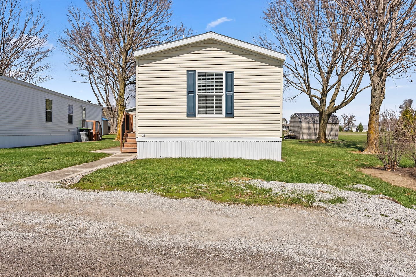 Front view of the home showcasing a peaceful neighborhood setting with open green space.