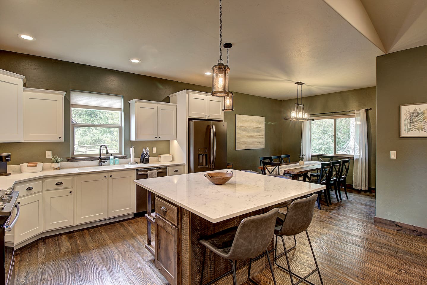 Home-cooked meal in this bright, fully stocked kitchen, gather around the dining table with a view of the trees for good food and company.