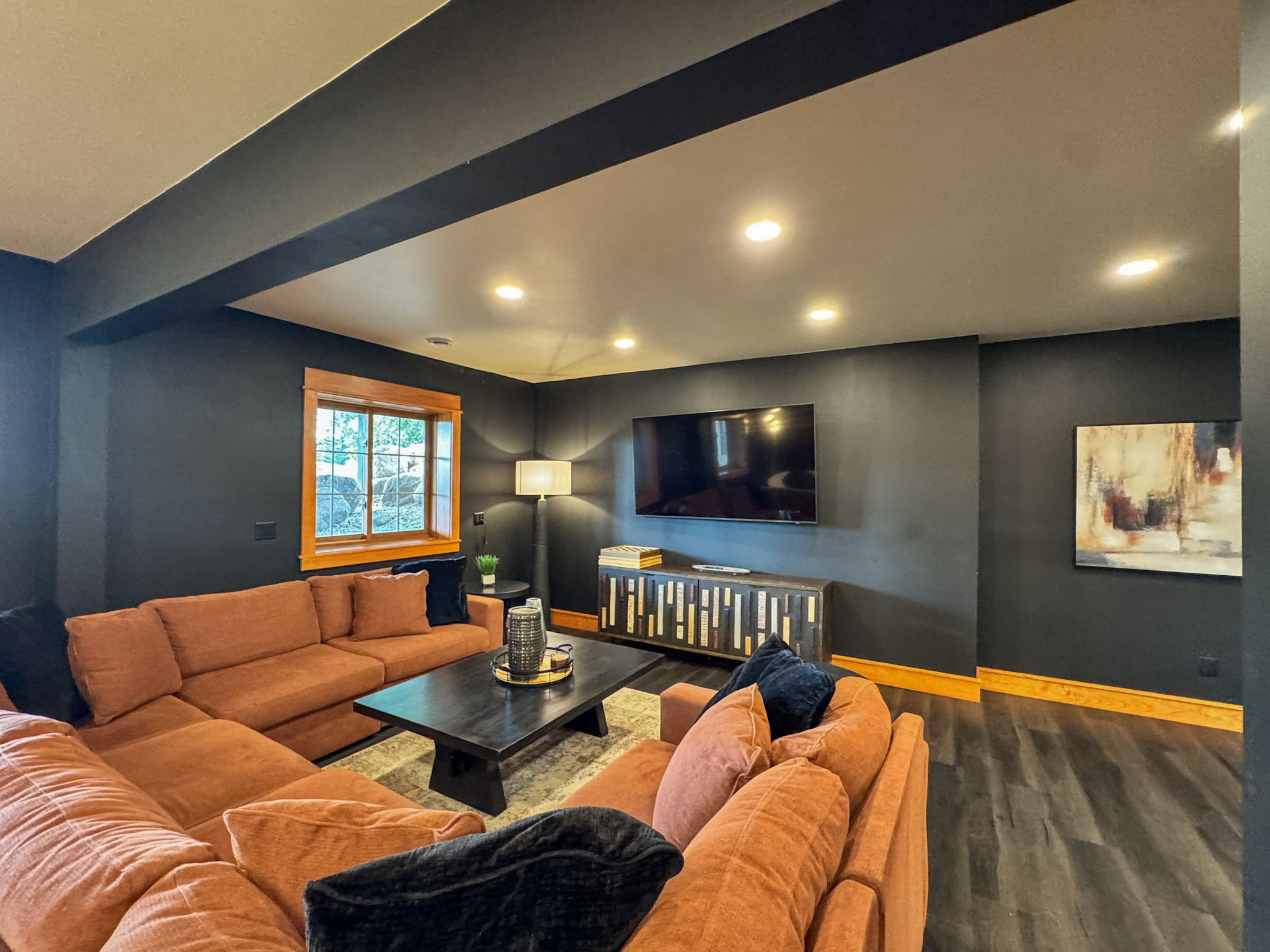 Downstairs TV lounge with spacious sectional seating.