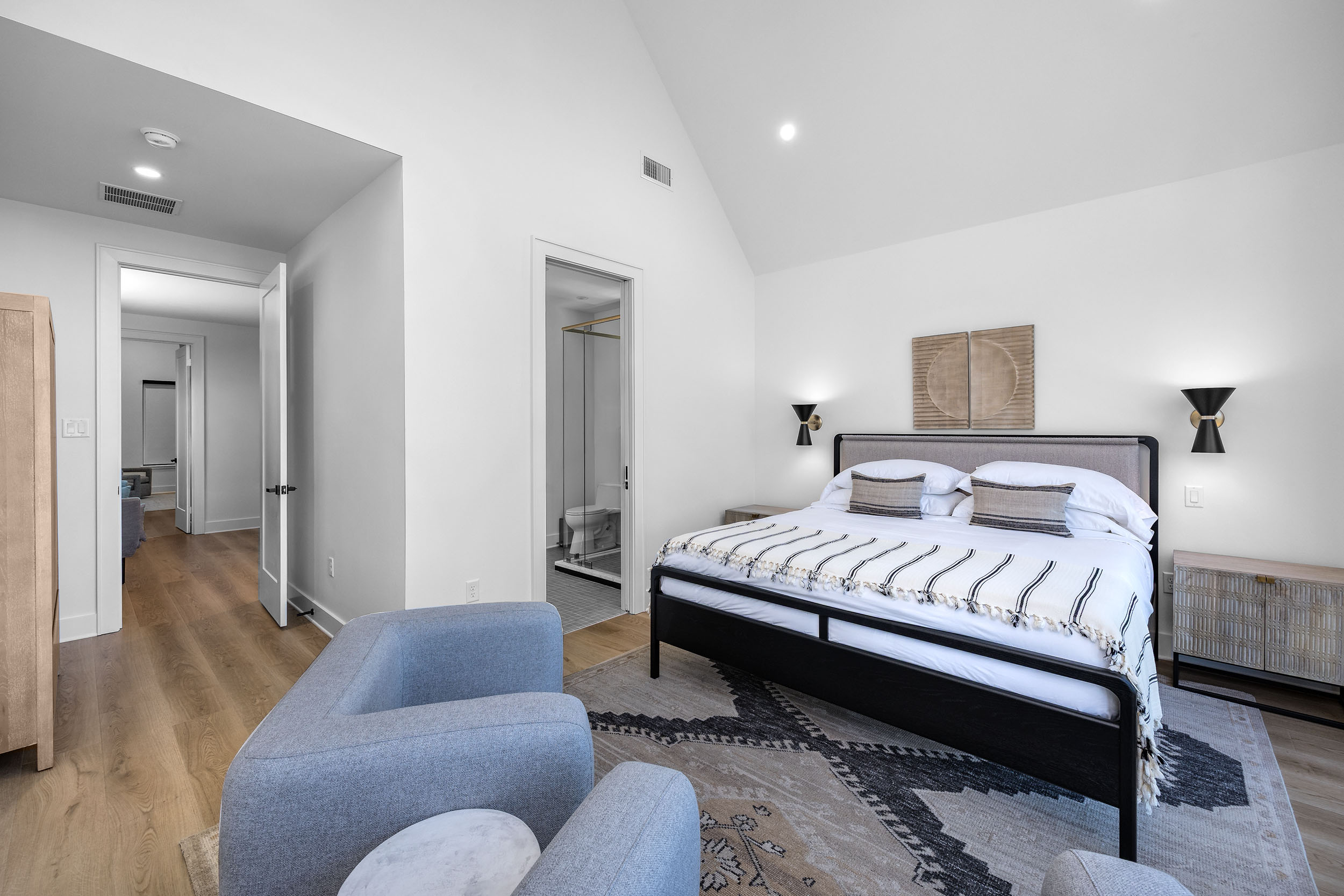 Vaulted ceilings, lake views, and designer touches make this king bedroom a guest favorite.