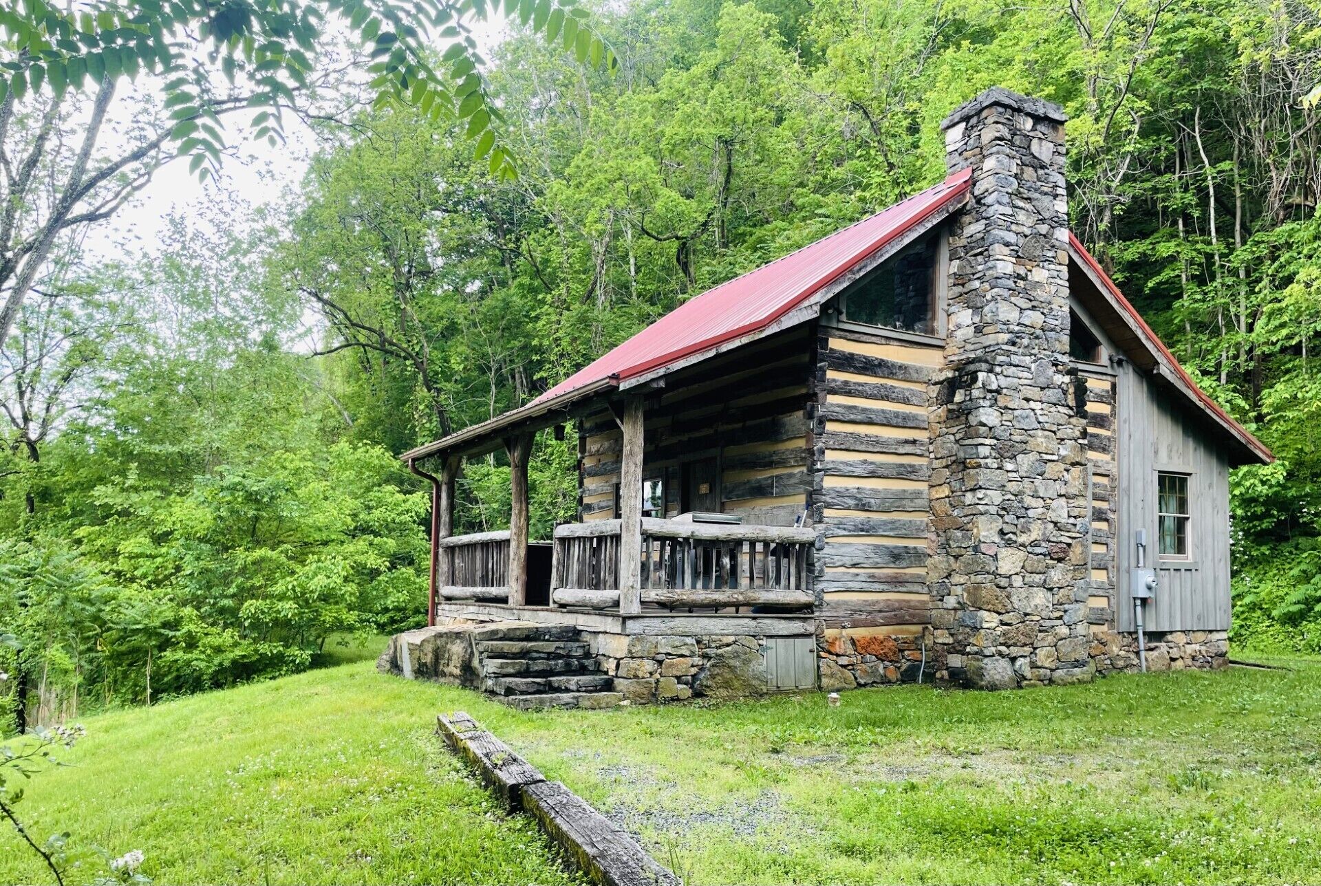 The side of the cabin where you pull up to park and enter onto the front porch