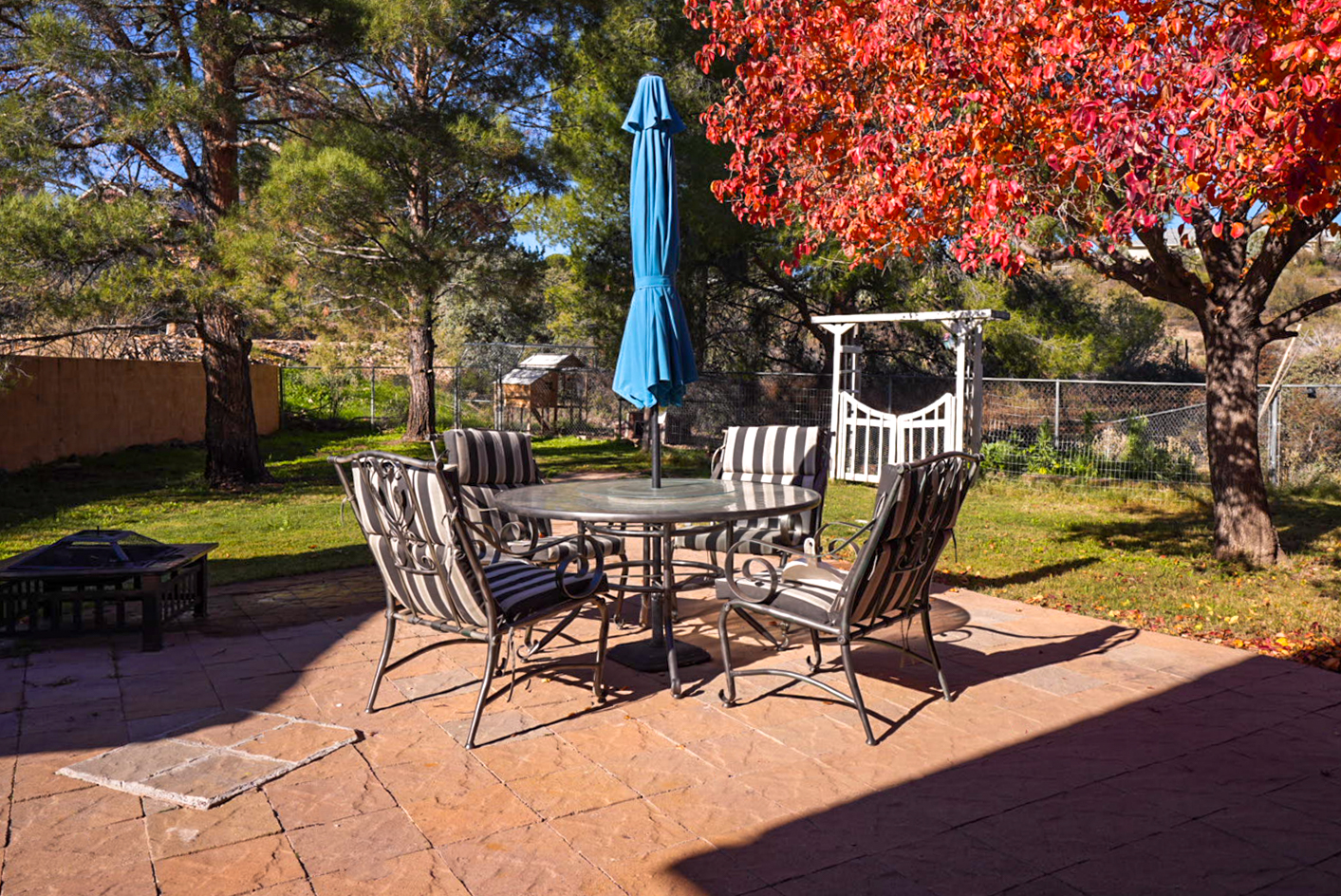 Shaded outdoor dining area surrounded by mature trees—ideal for relaxed meals and long conversations.