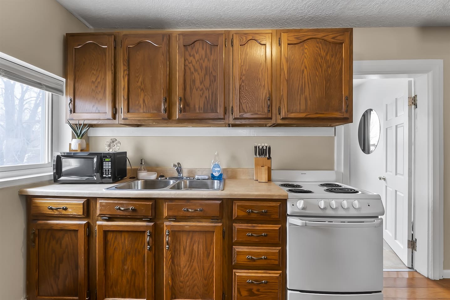 Fully equipped kitchen featuring a gas stove, microwave, and all the cookware and supplies you need to prepare delicious meals.