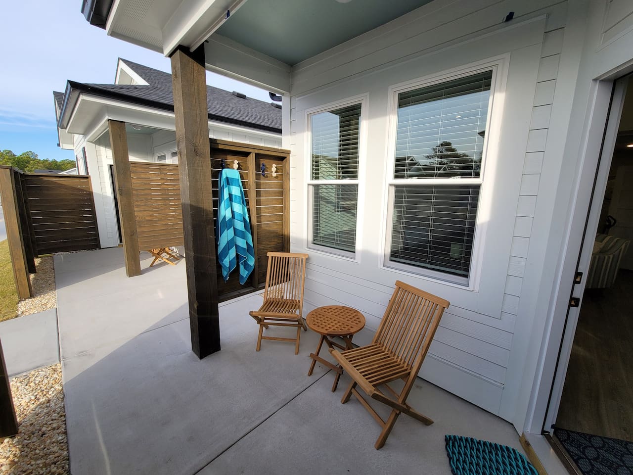 Covered patio has seahorse hooks for air drying your beach towels.  