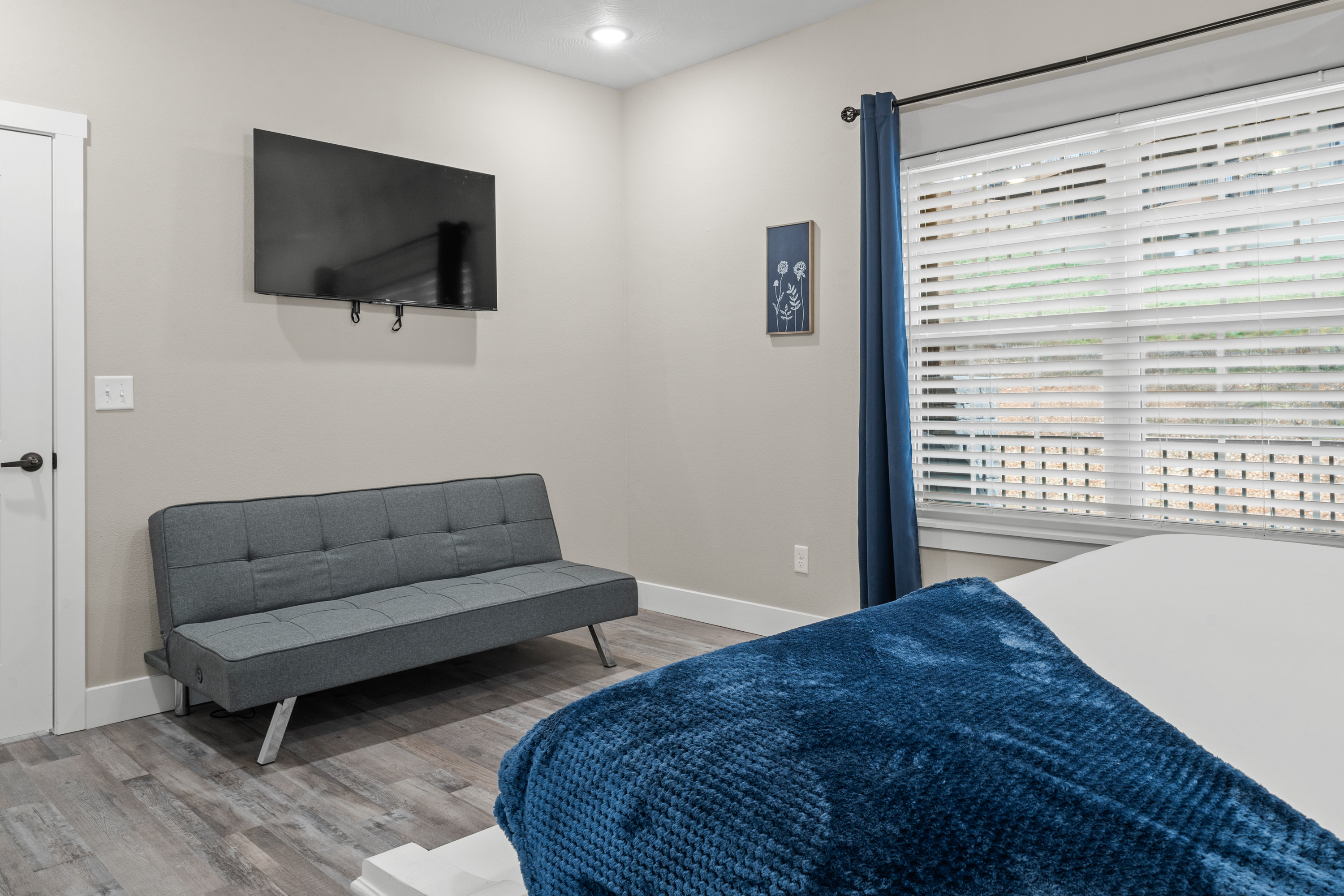 Master Bedroom #1 has a click clack sofa that converts to a bed and a TV